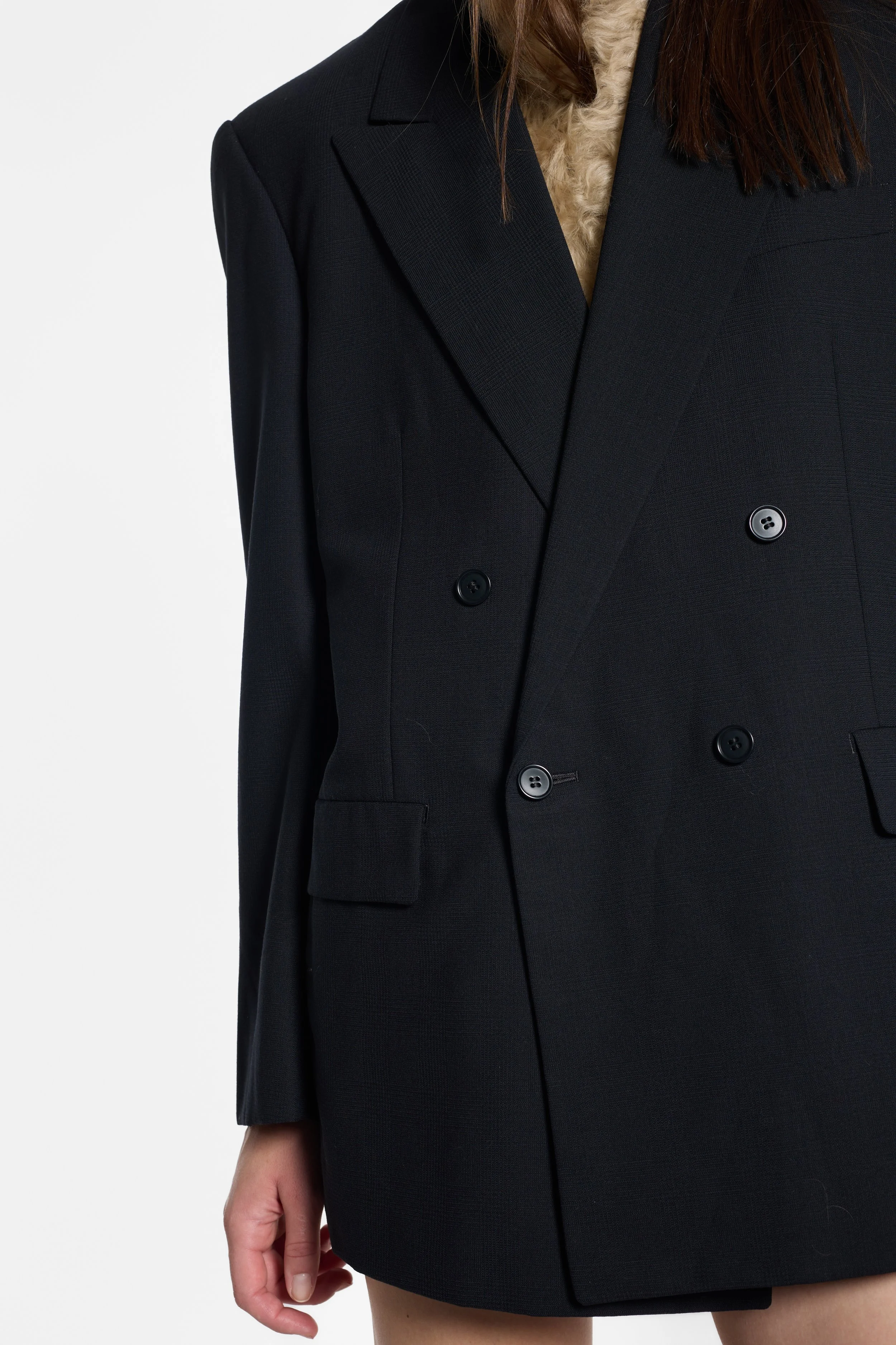 Close-up of wide peak lapels and four-button fastening on Yohji Yamamoto blazer