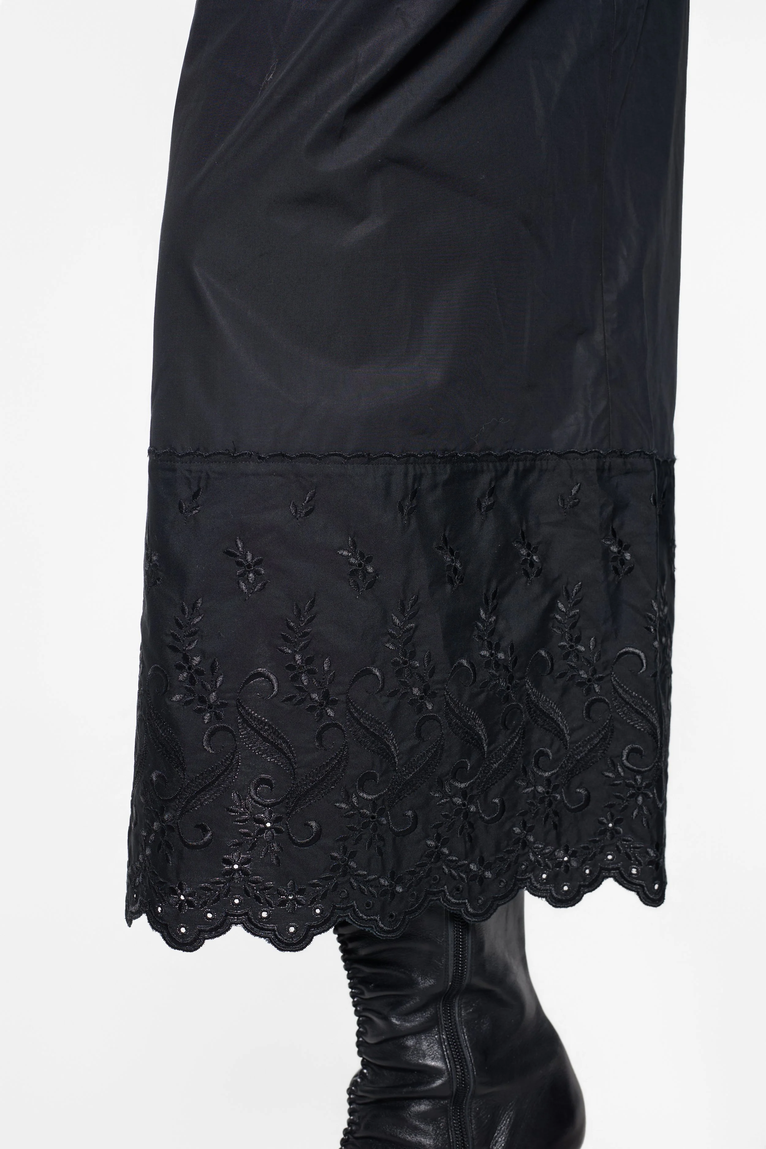 Close-up of floral broderie anglaise embroidery on Simone Rocha trouser hem
