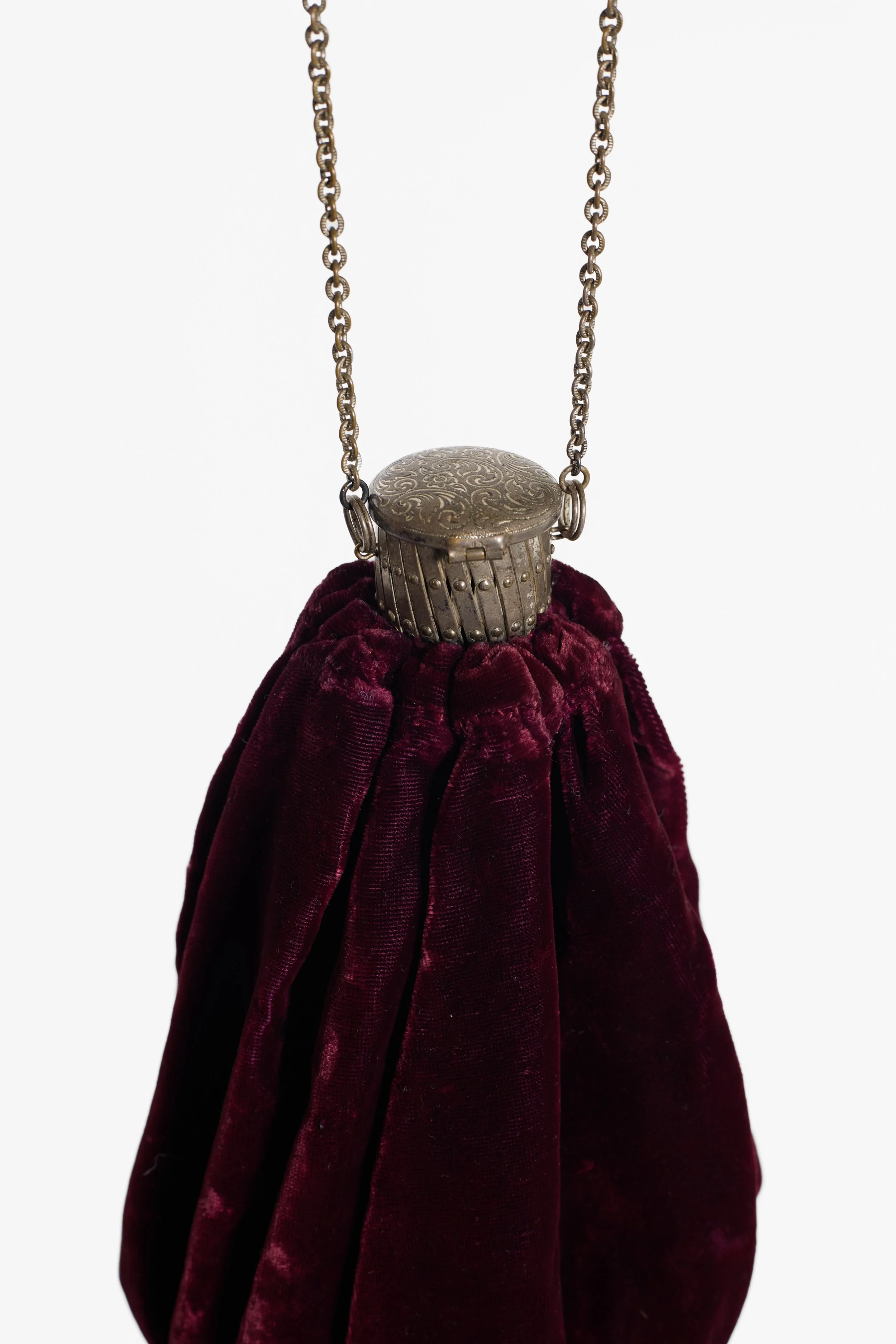 Antique velvet chain purse showing decorative silver-tone clasp