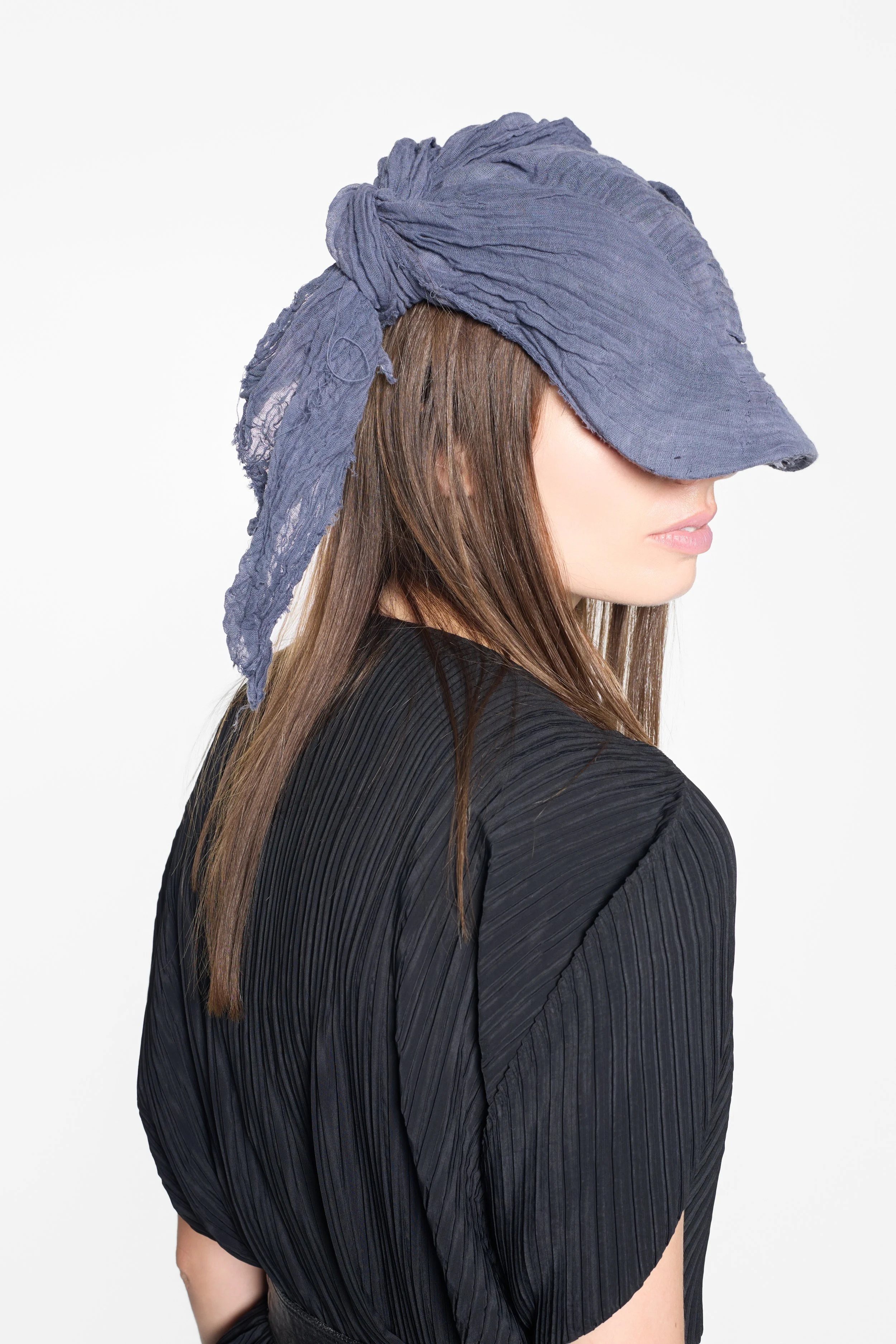 Detail of slate grey cotton layers and adjustable cap fastening