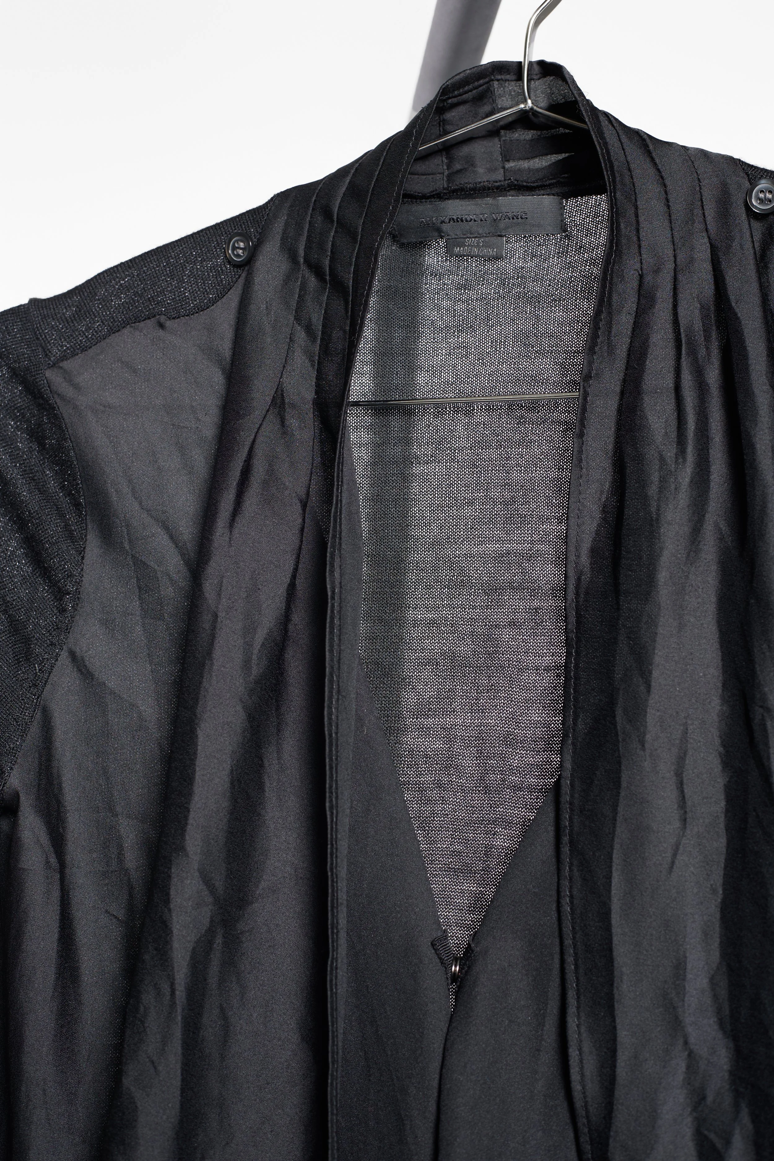 Close-up of Alexander Wang open-knit sleeve and draped front