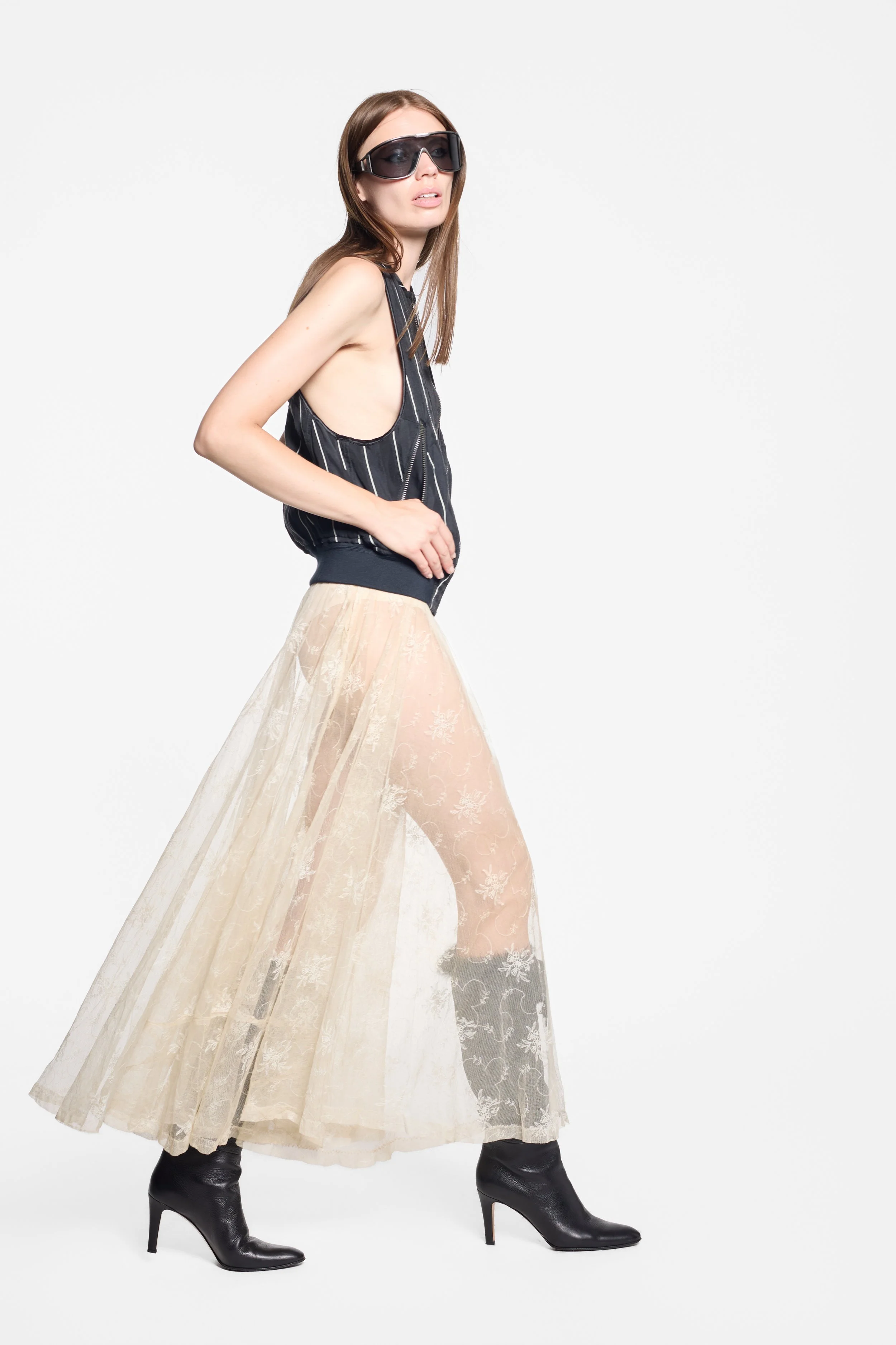 Haider Ackermann SS18 black pinstripe vest styled on model, full-length editorial image of her caught in motion