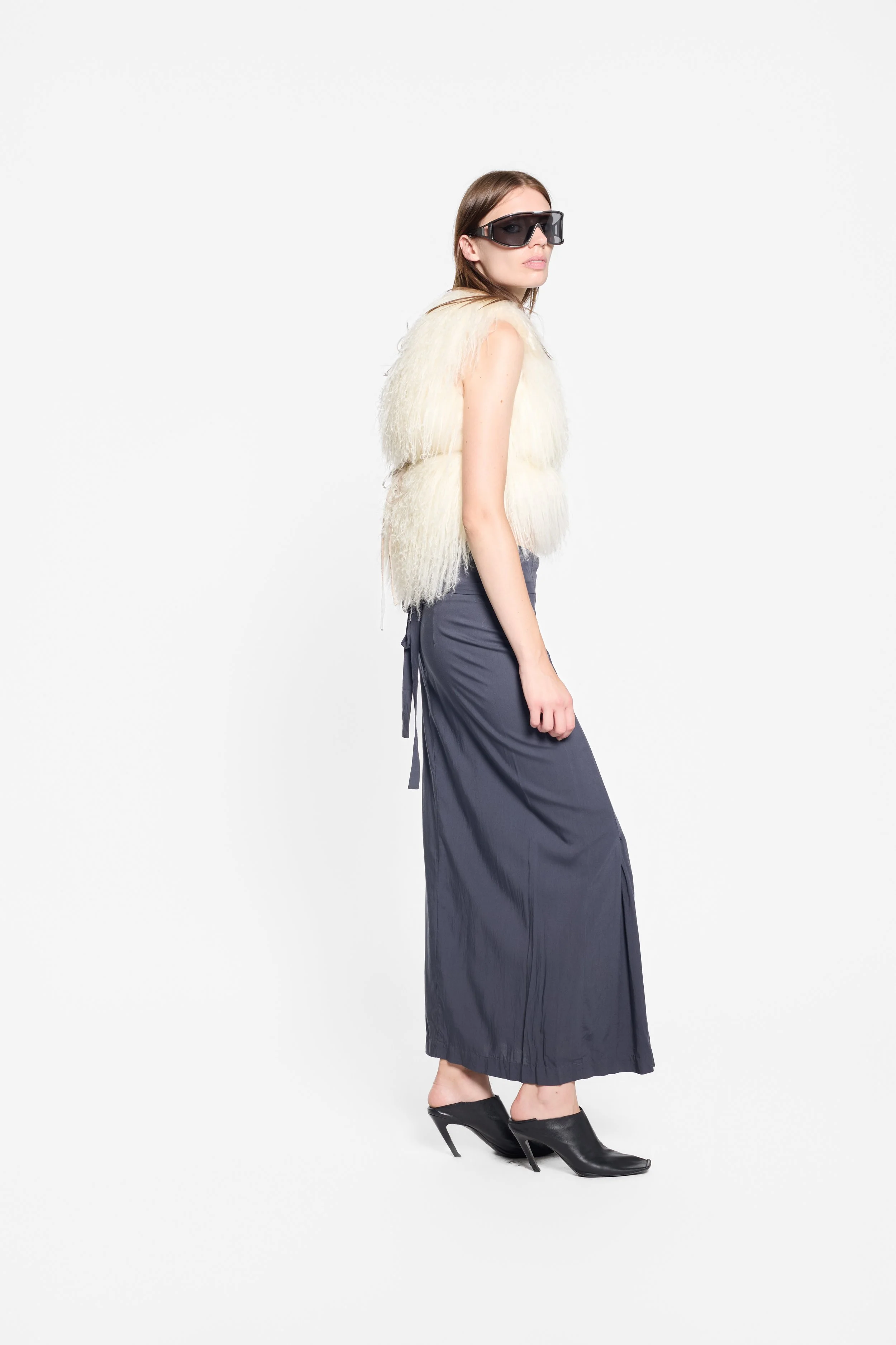 Full-length editorial view of vintage ivory shaggy fur gilet