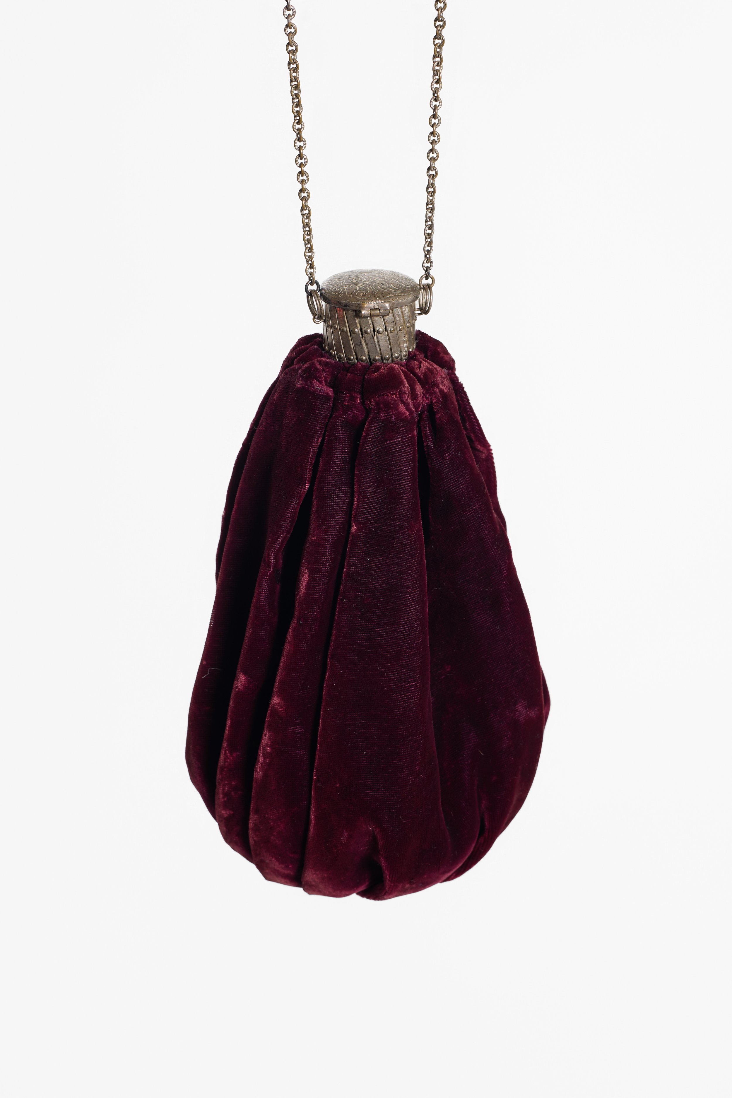 Antique burgundy gate-top bag showing gathered velvet construction