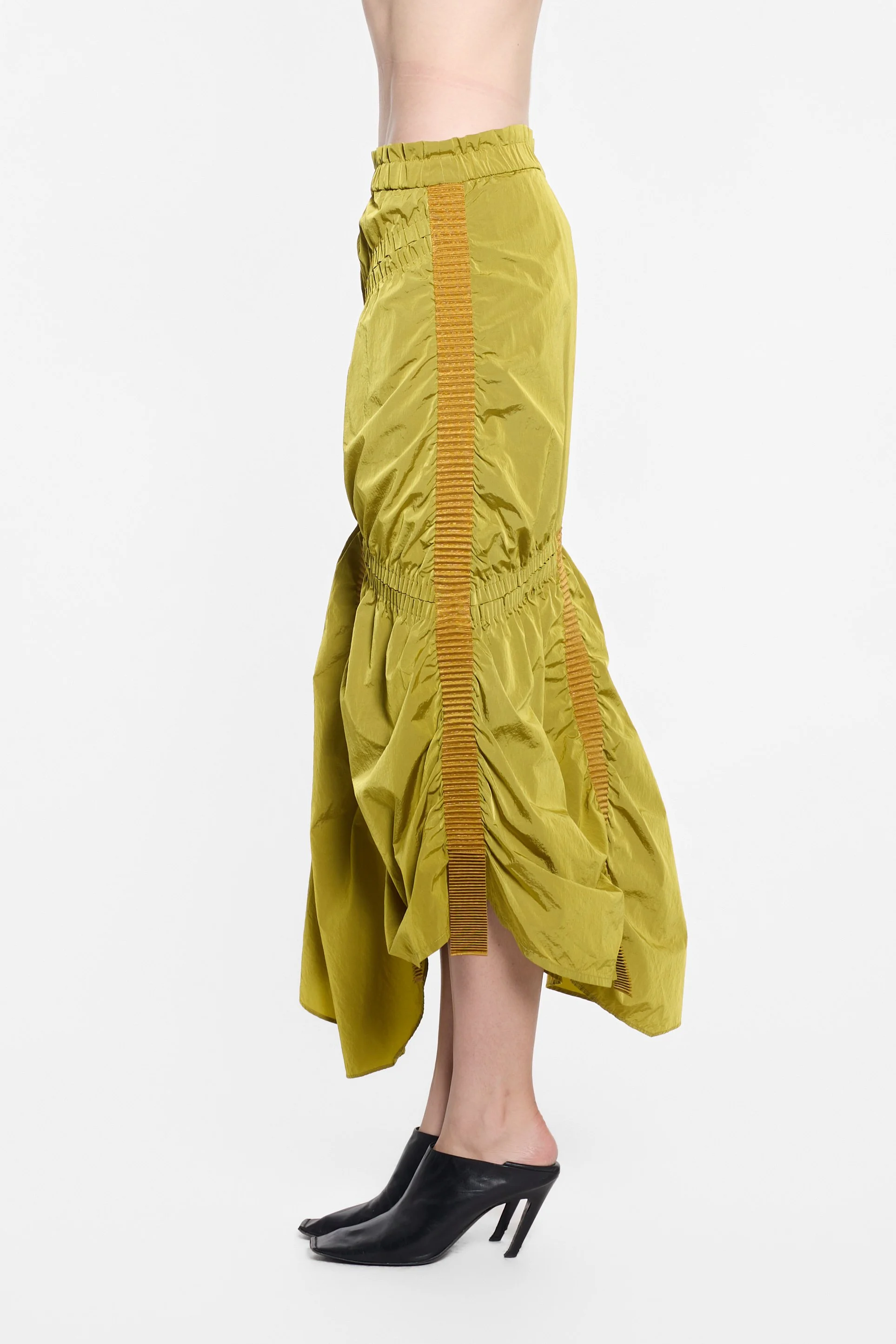 Side view of UN3D asymmetric nylon skirt with layered panels