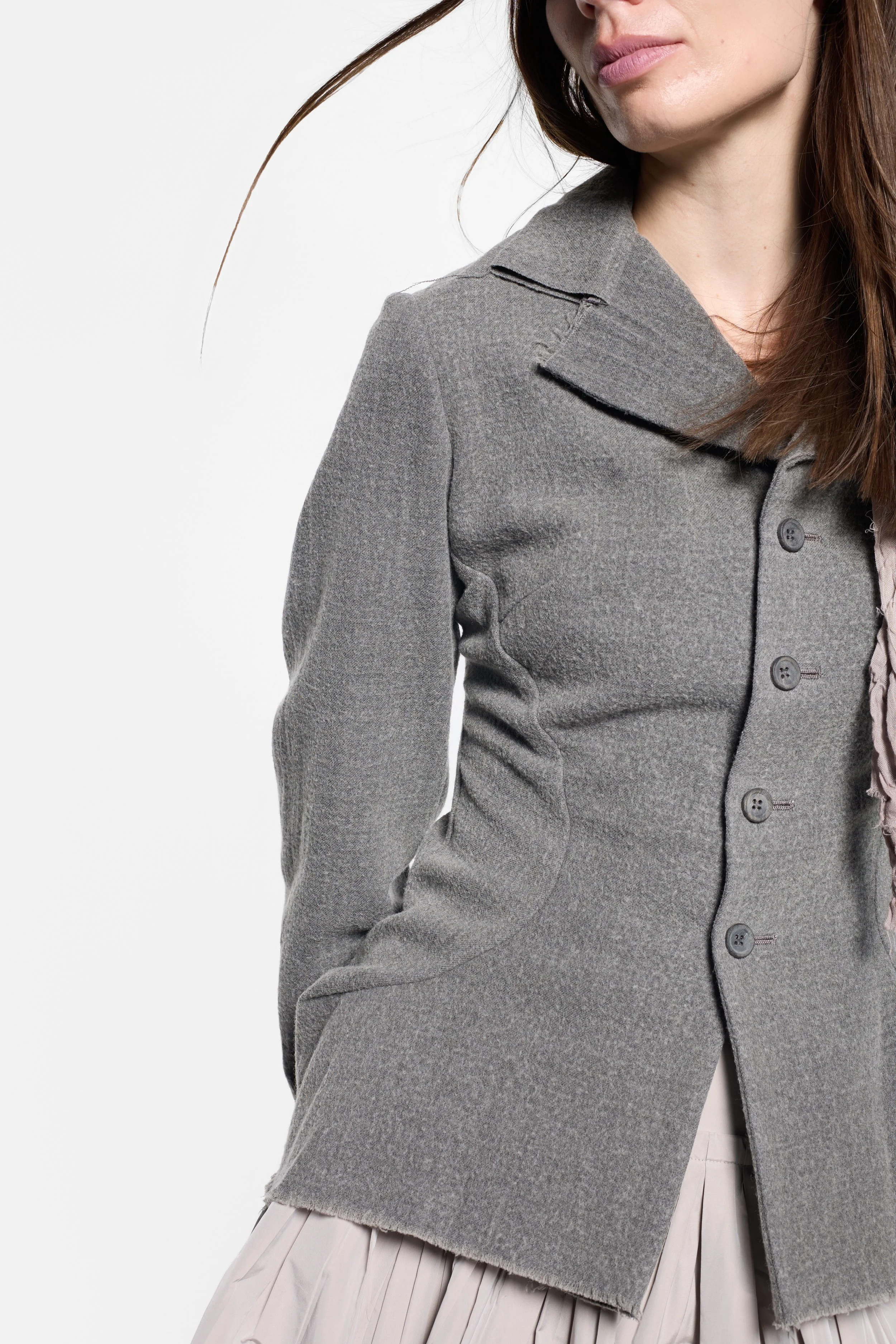 Close-up of raw unfinished edges and wide notched lapels on Junya Watanabe jacket