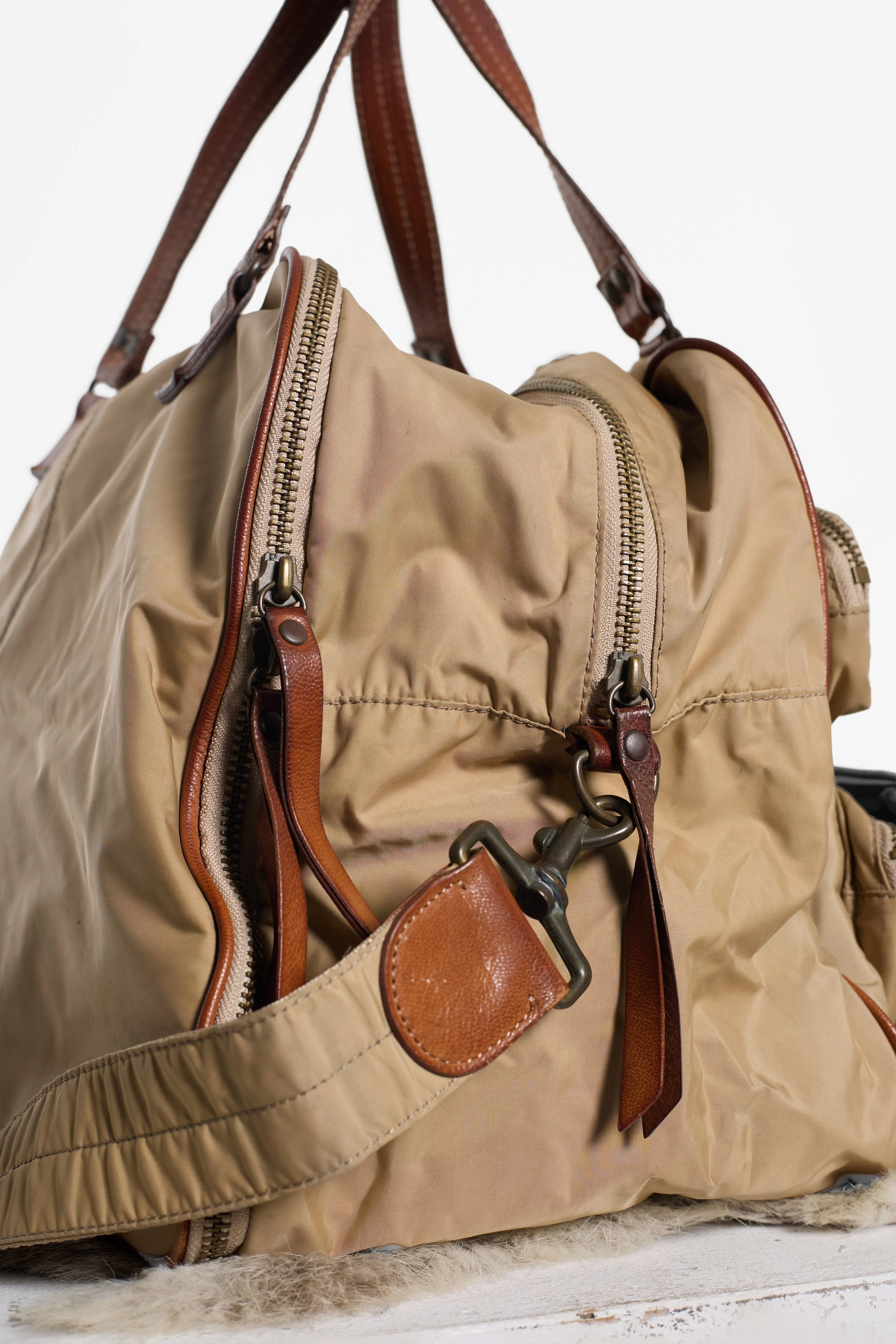 Close up side view of Y'SACCS khaki bag showing wide gusset and shoulder strap hardwareose up