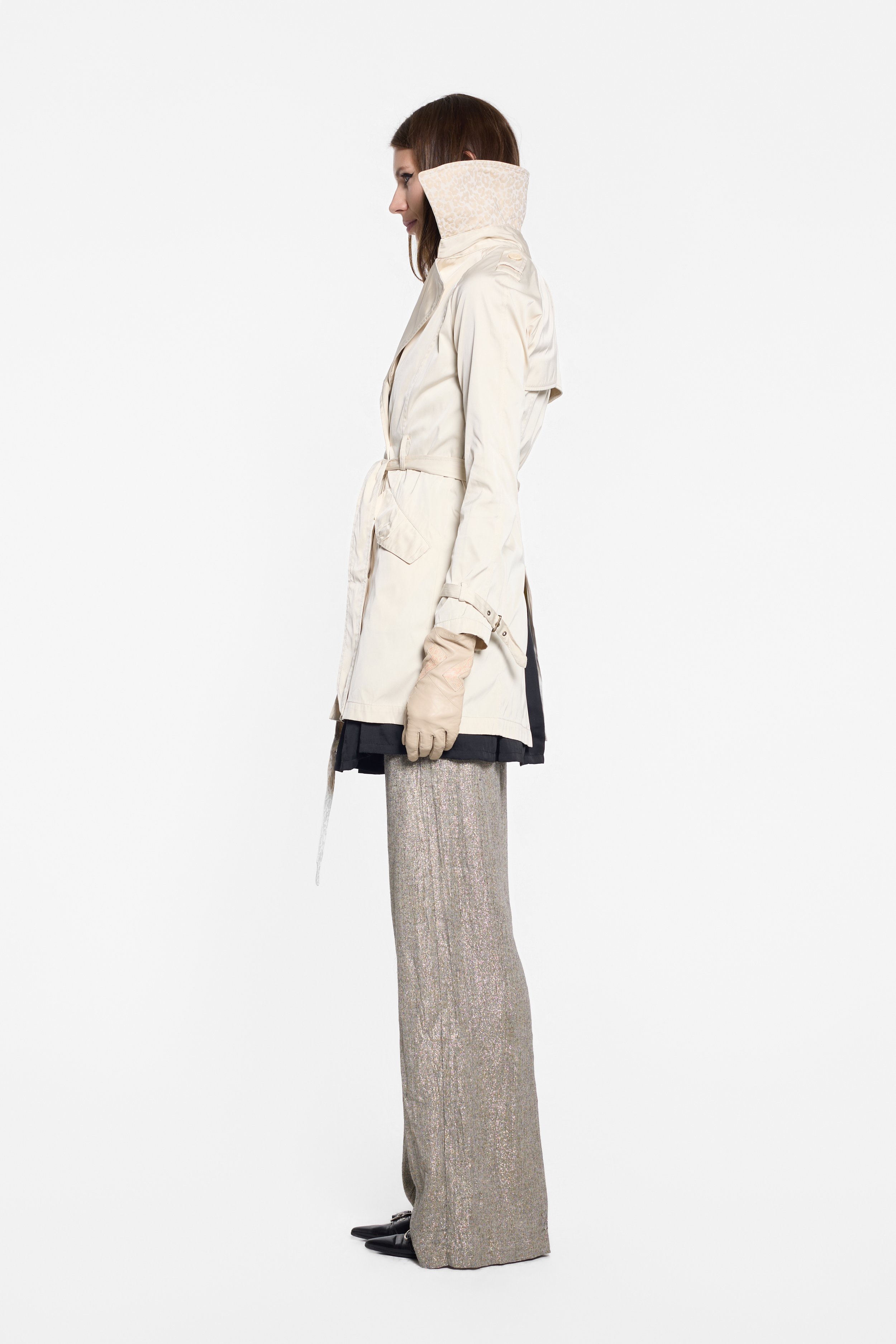 Side view of Chelseagarb belted coat with flap pocket and buckled cuff