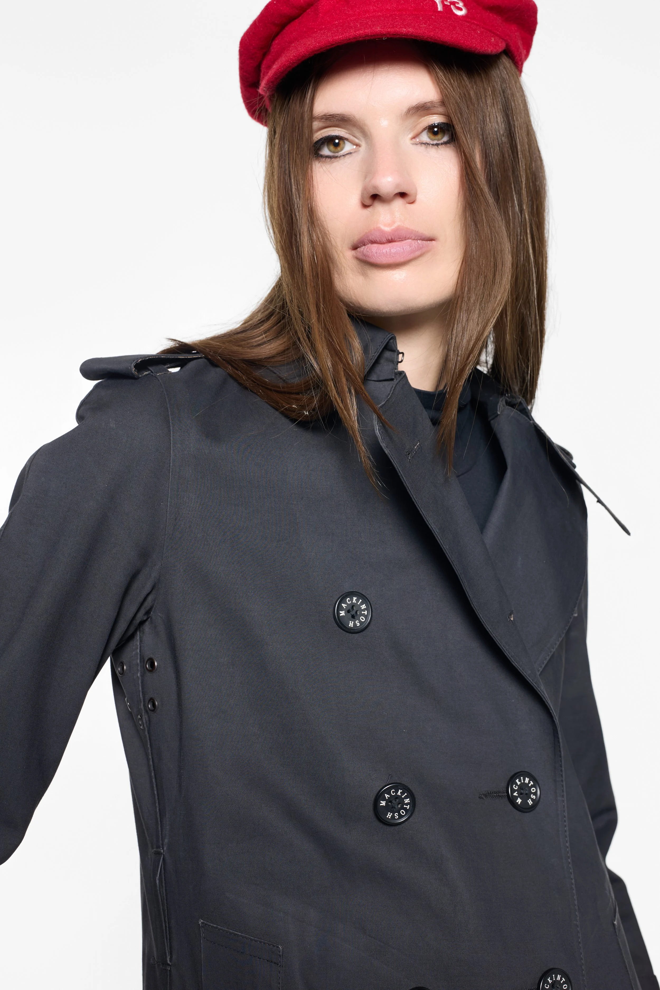 Close-up of branded buttons and wide notched lapels on Mackintosh coat