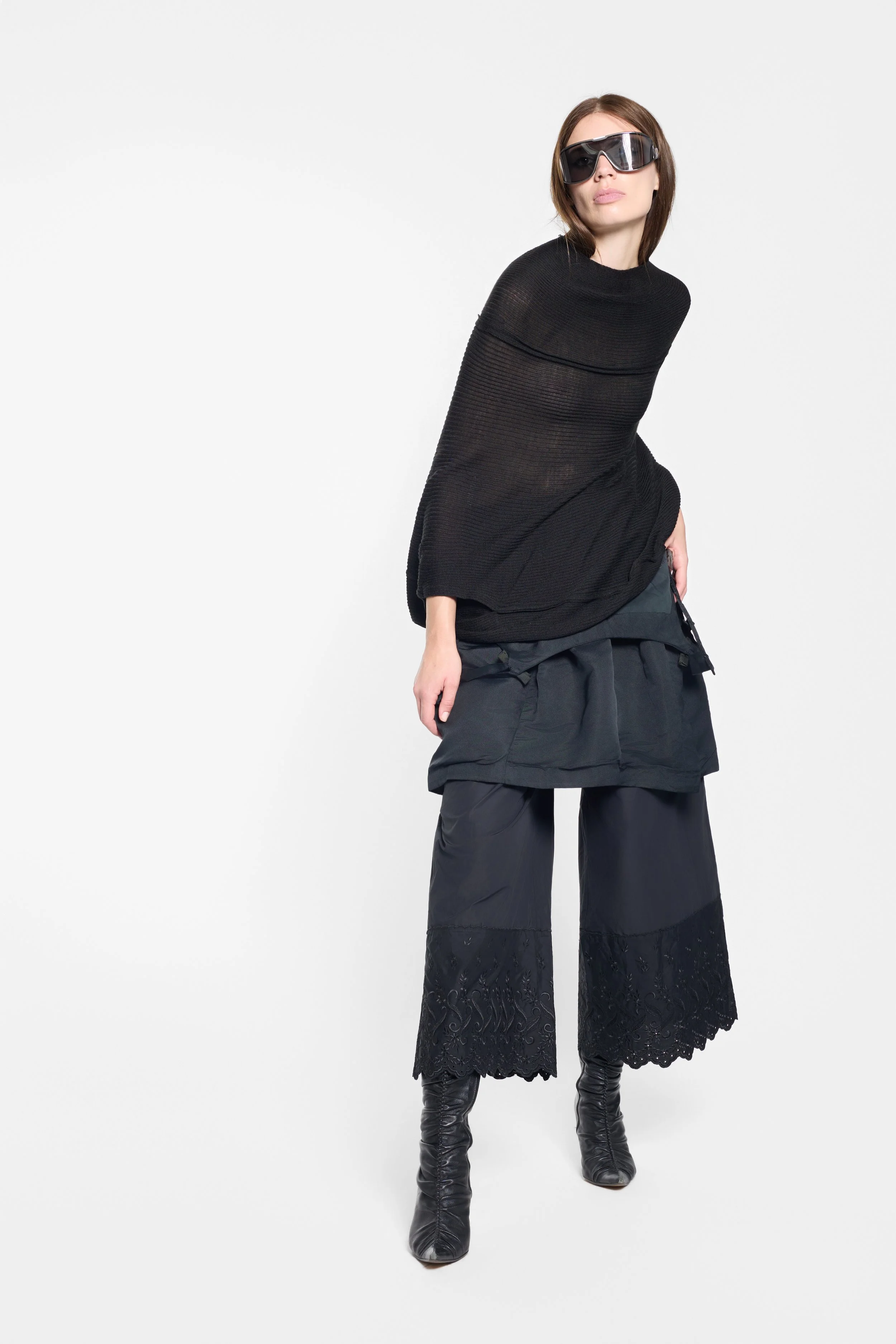 Model styling the Harvey Berin black dress with a sheer black Junya Watanabe jumper