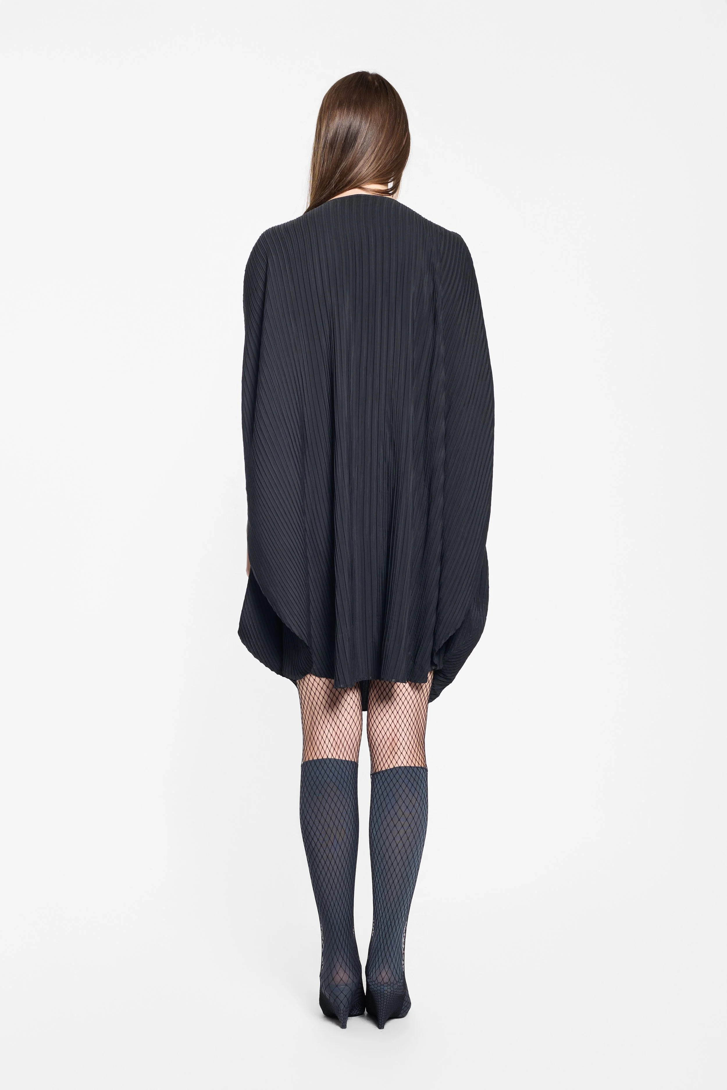 Rounded silhouette and back drape of the Issey Miyake dress