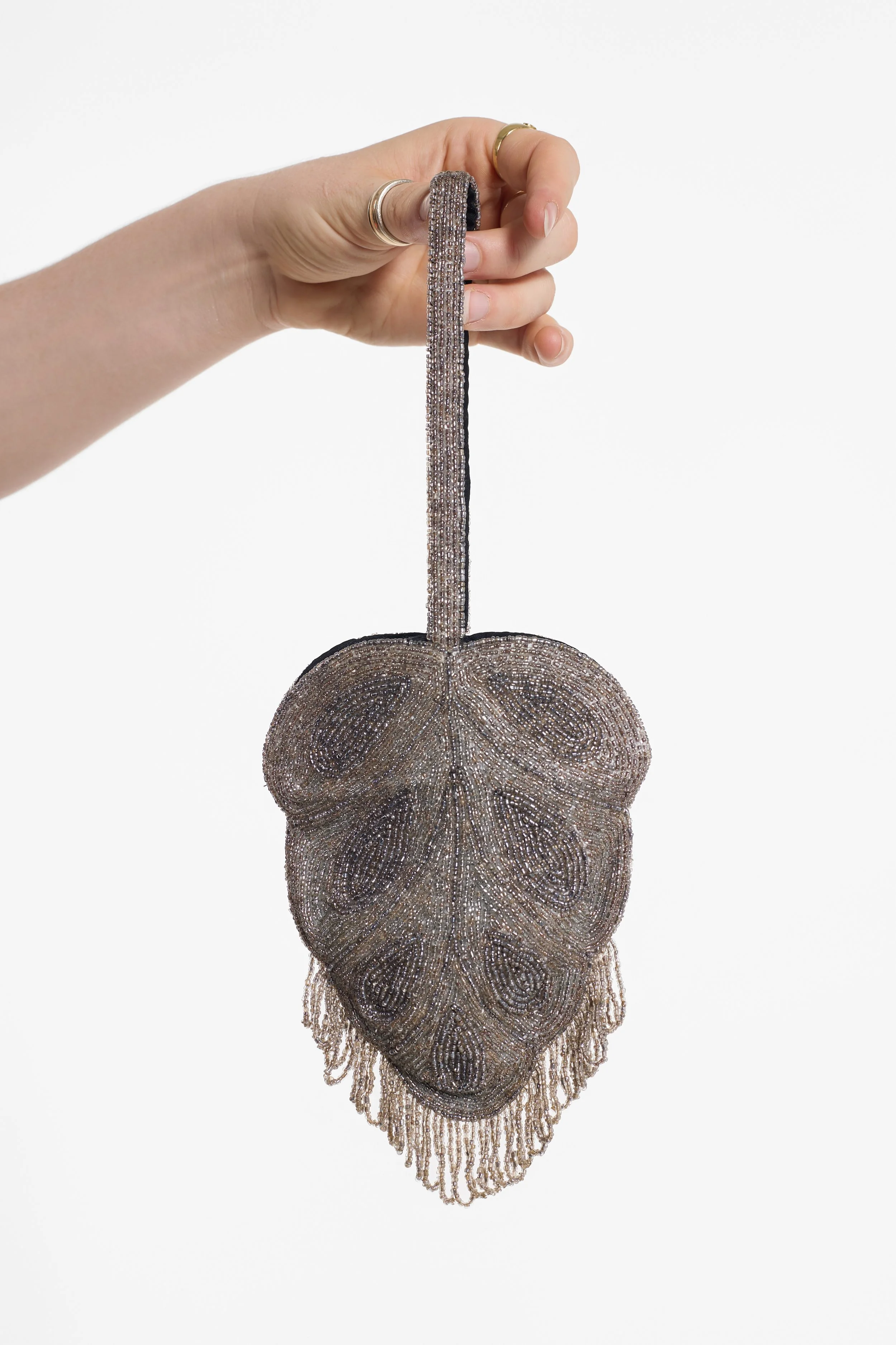 Hand-held Jamin Puech evening bag showing beaded handle and fringed hem