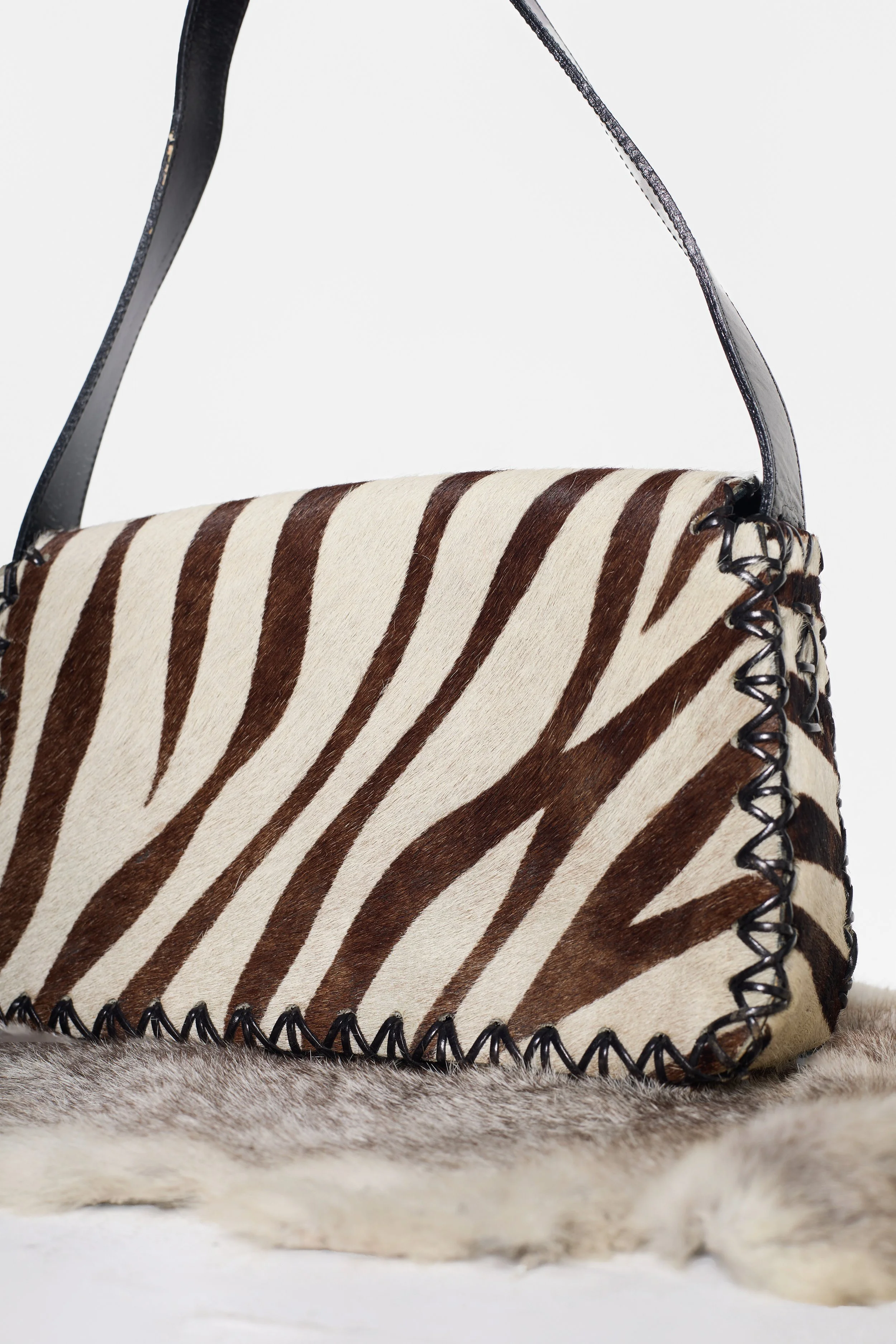 Back view of Russell & Bromley cowhide handbag with leather strap