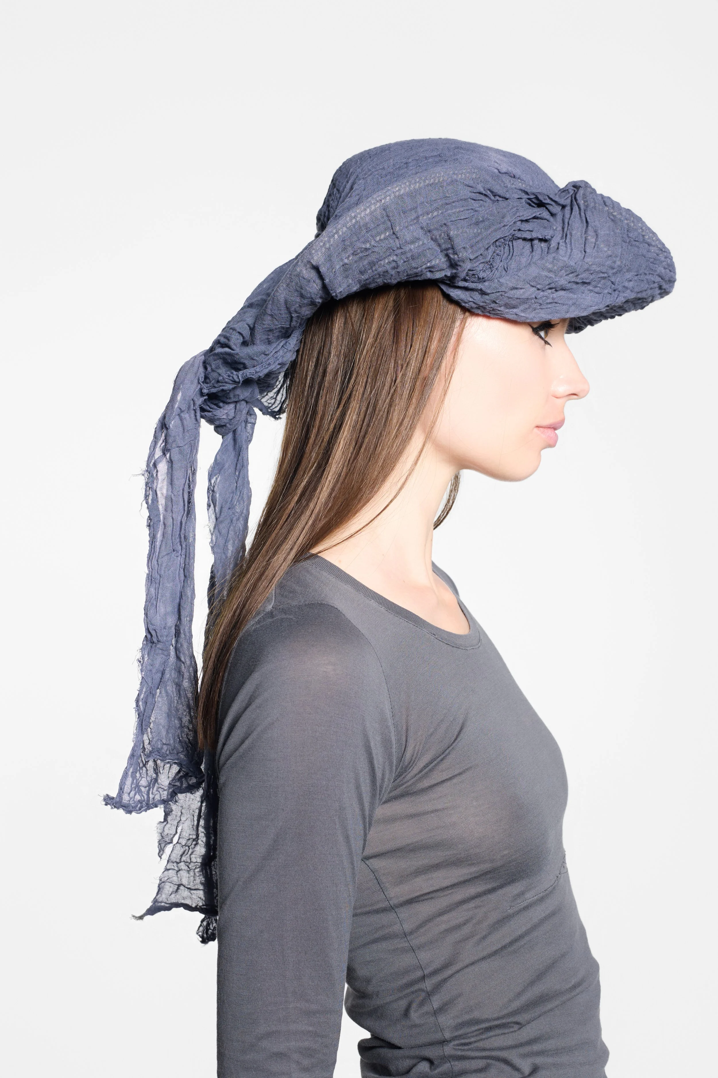 Detail of sculptural tricorn construction and raw slate grey fabric edges