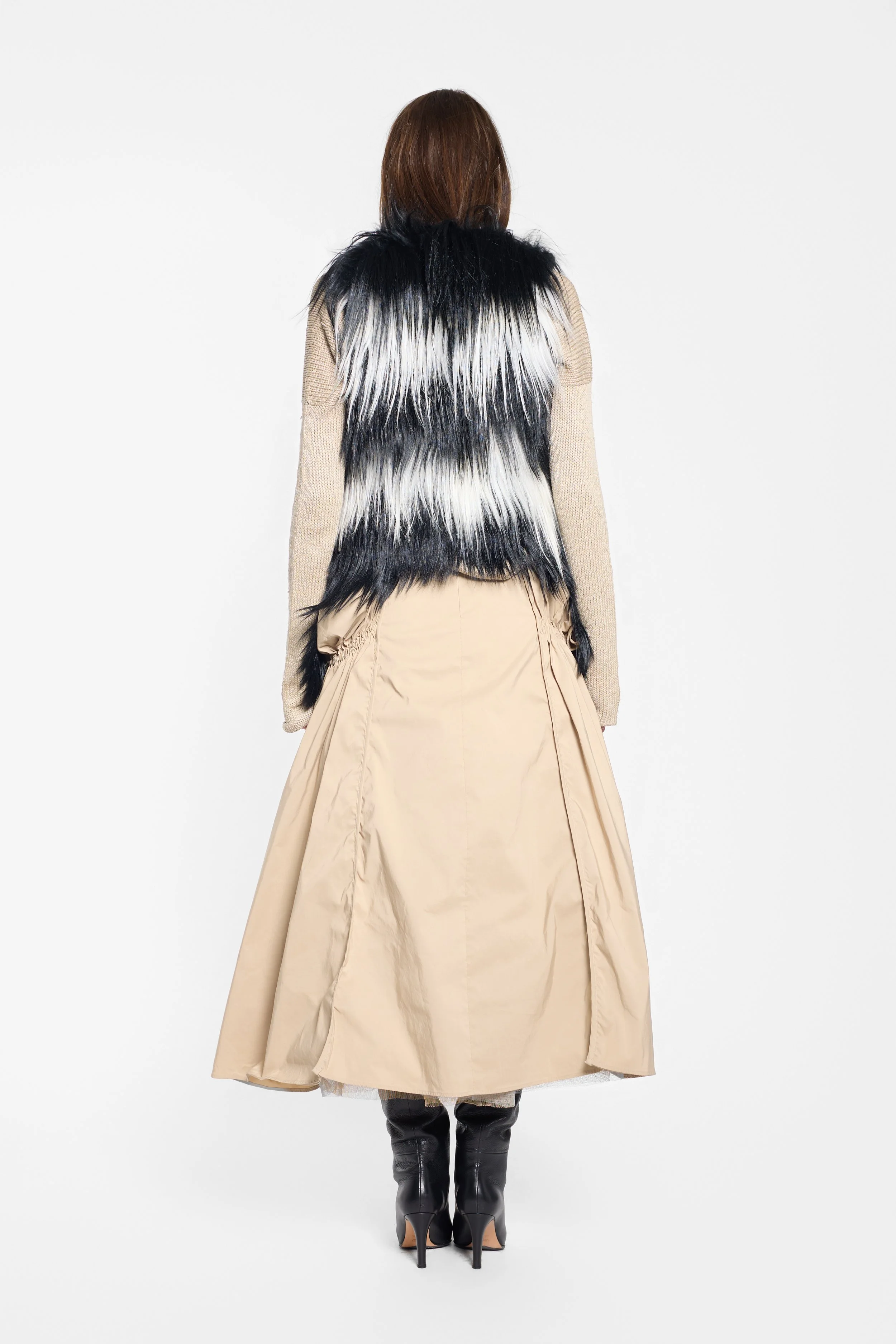 Back view of black and white long-haired fur gilet
