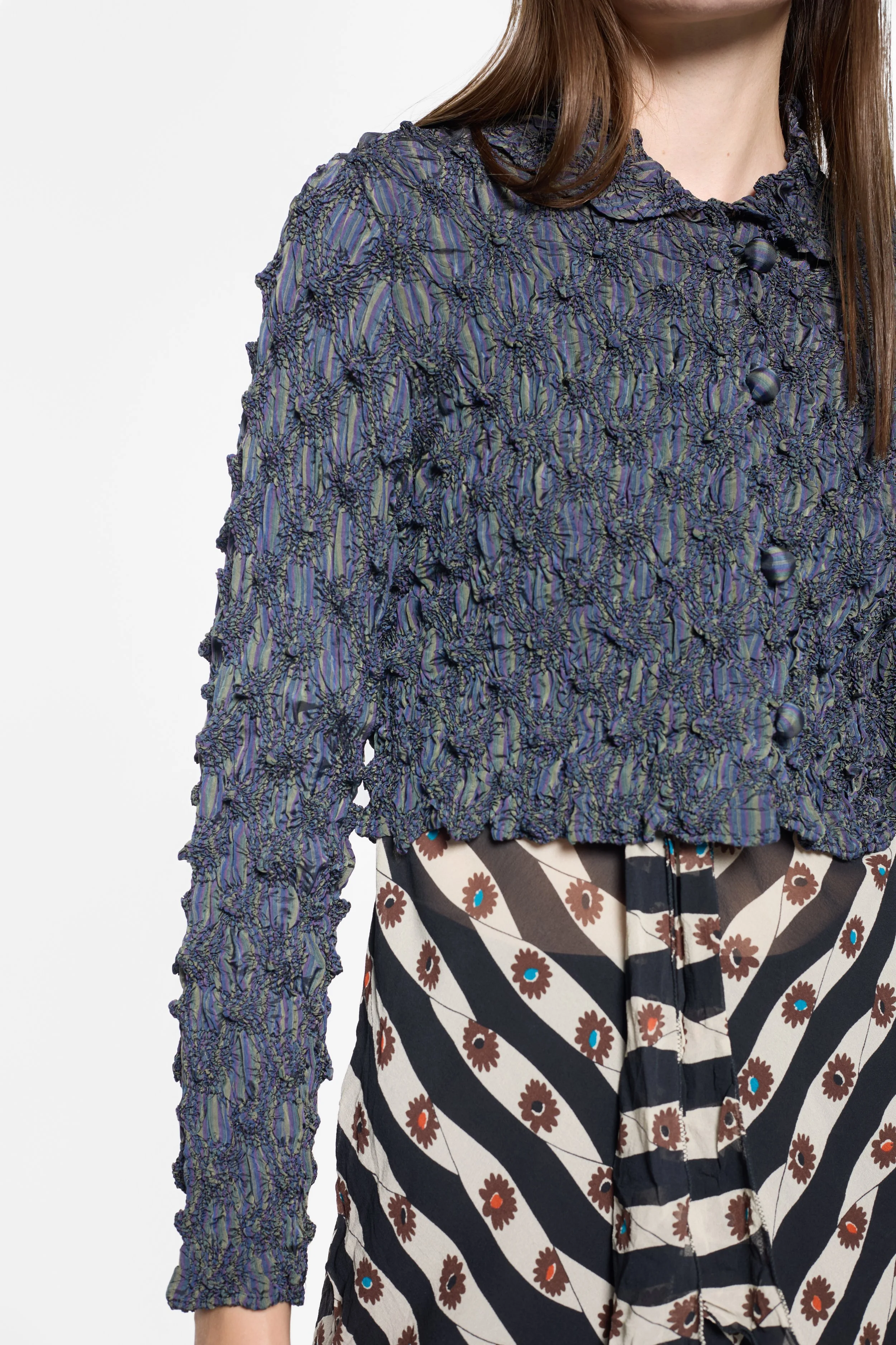Close-up of gathered smocking and striped cupro on Kensho Abe jacket
