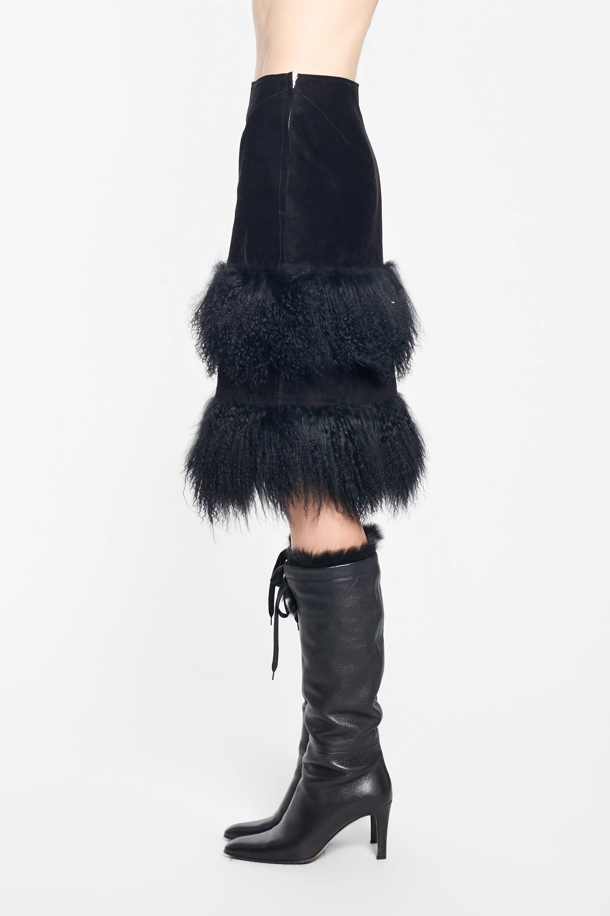 Side view of black leather pencil skirt with fur trim