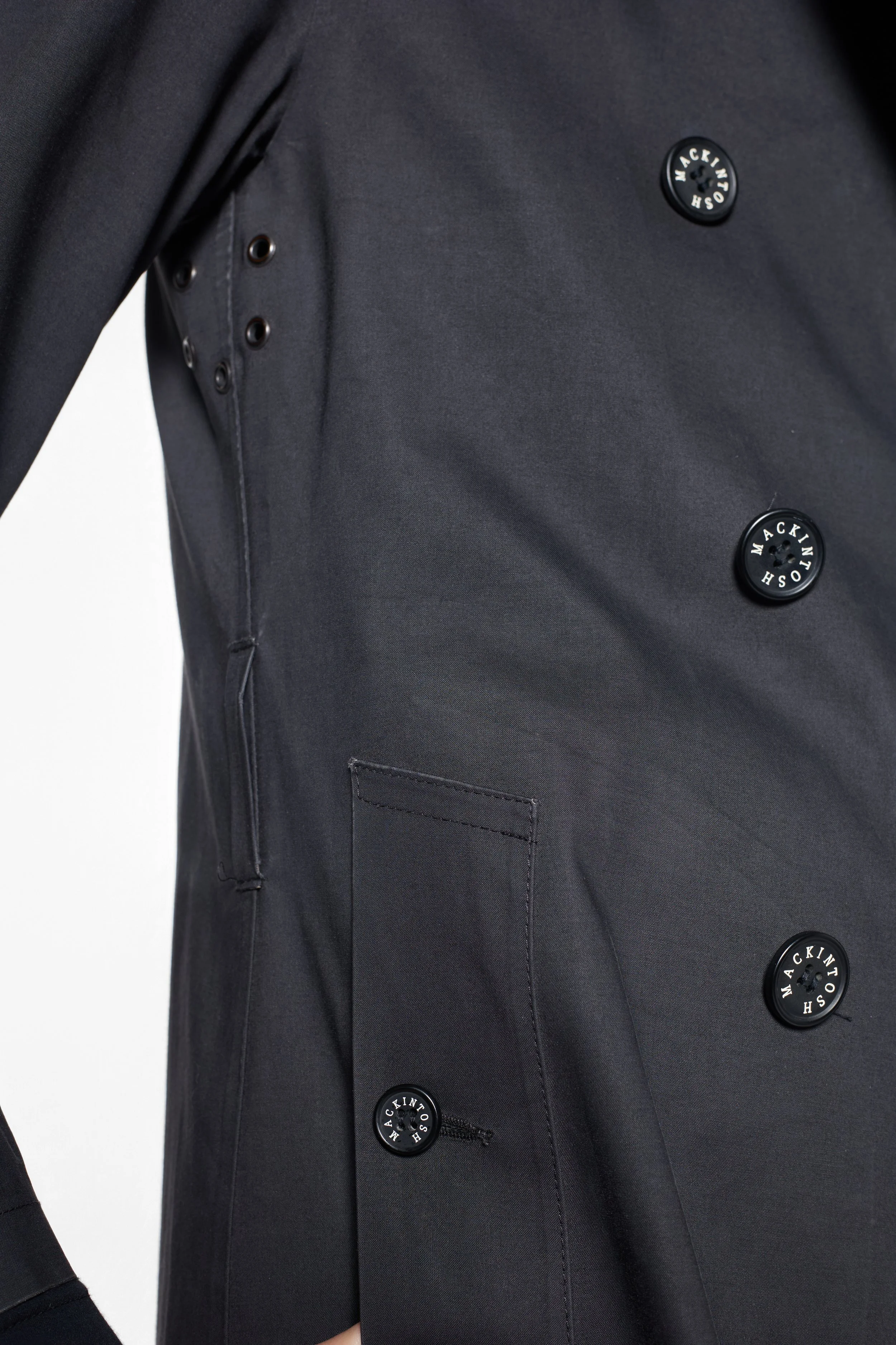 Another close-up of branded buttons and wide notched lapels on Mackintosh coat