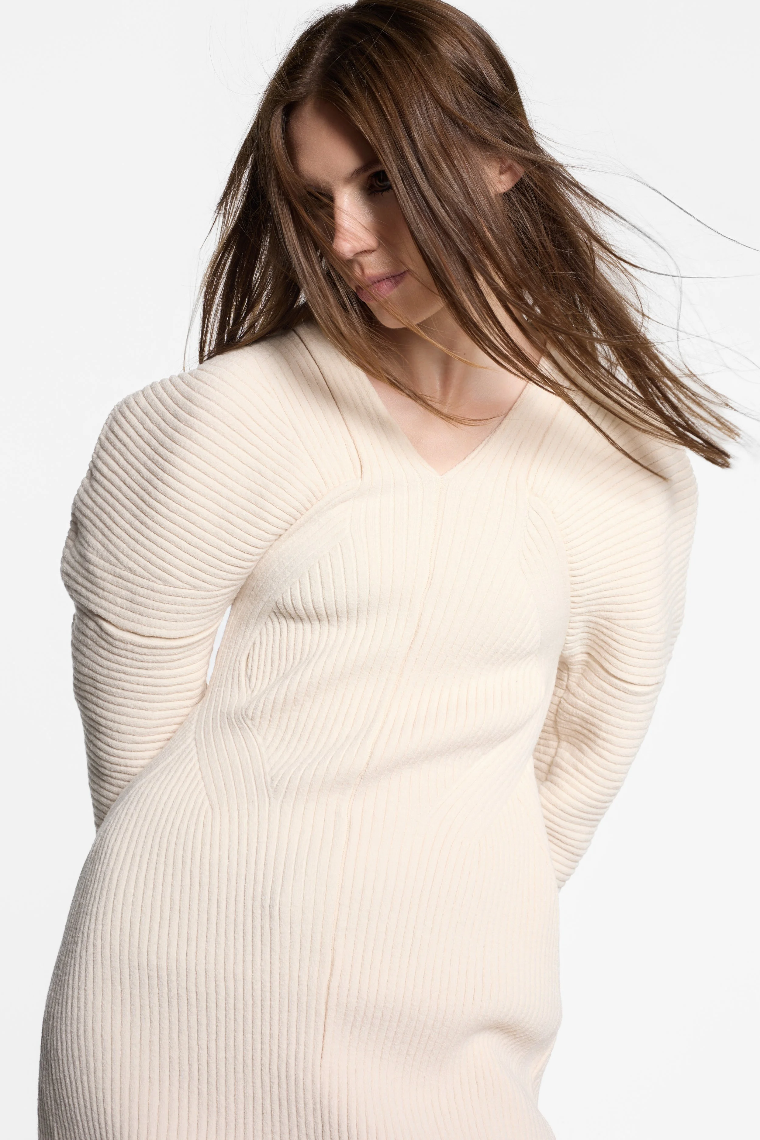 Detail of exaggerated rounded shoulder and tapered sleeve on IRENE knit dress