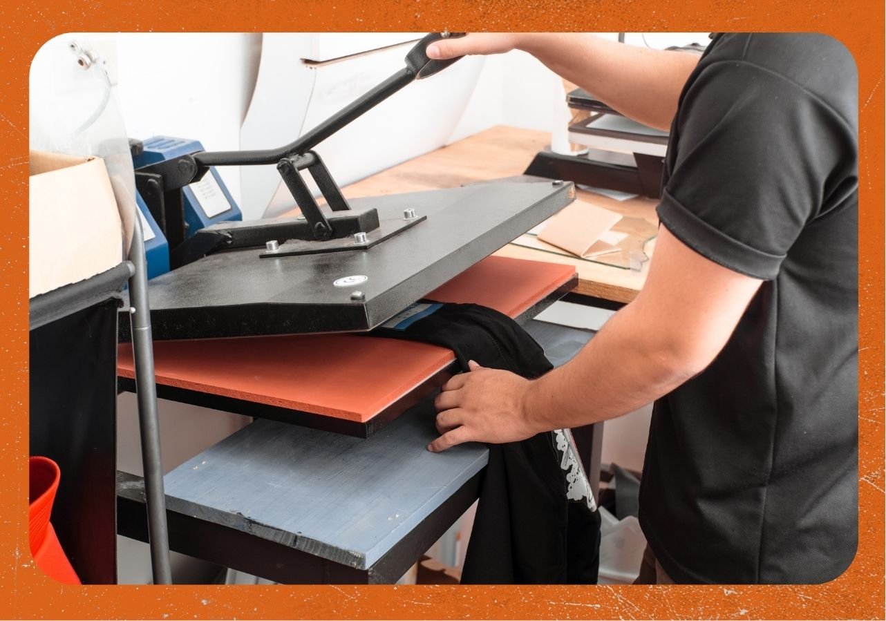 Man using heat transfer to apply graphics on t-shirt