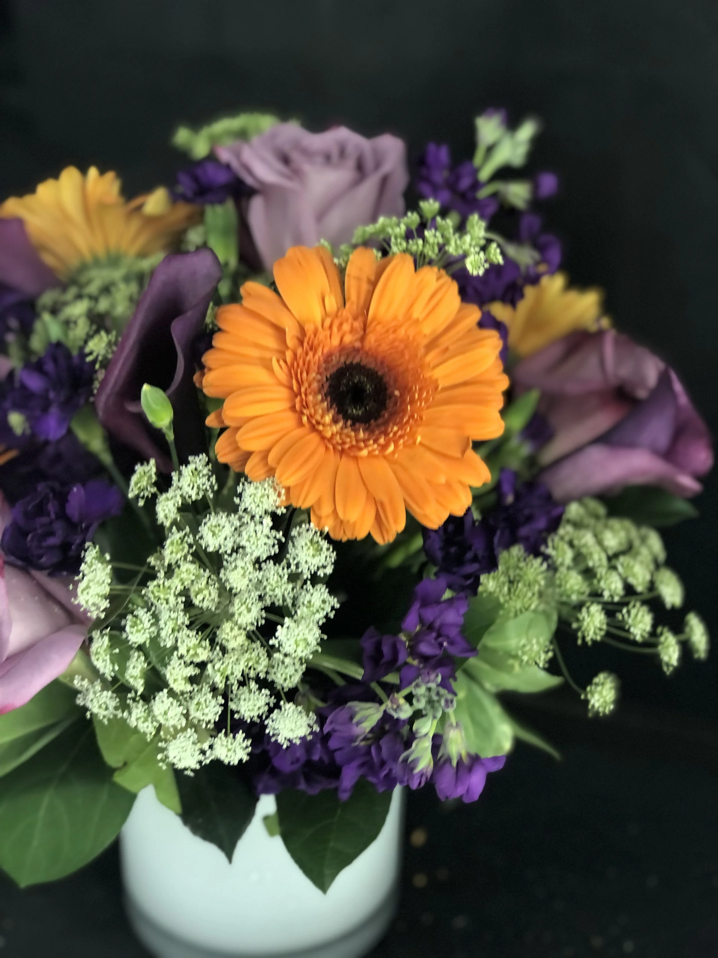 Queen Anne's lace, purple rose, orange Gerbera drama wedding arrangement 