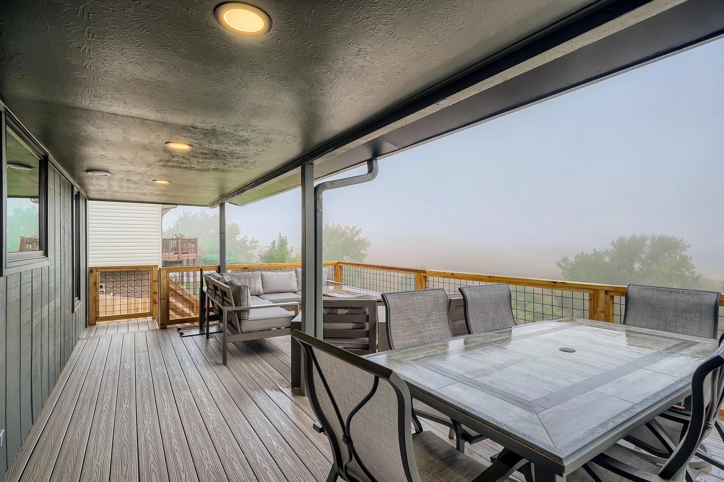 Custom composite deck with dining area and railing, built in the Denver metro area.