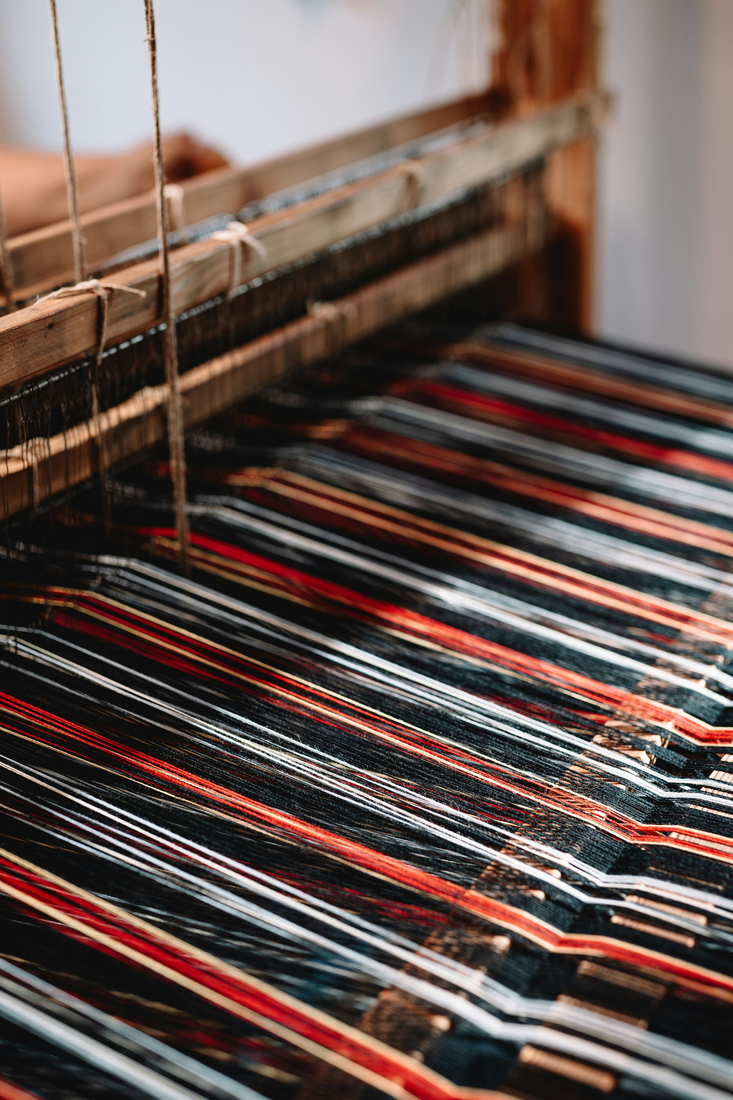 Photo of a loom by Anna Ansone on Unsplash