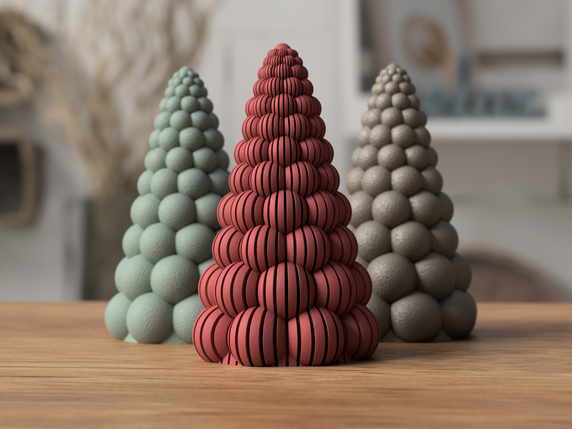 Three decorative cone-shaped sculptures made of spheres, with the middle sculpture consisting of red spherical discs, and the outer sculptures made of frosted gray and beige spheres, on a wooden surface in a room.