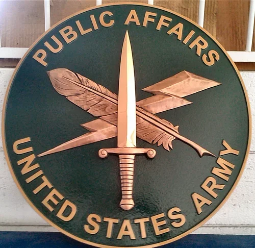 United States Army Public Affairs emblem created as a detailed 3d bas relief plaque featuring crossed symbols and raised lettering typical of military bas relief plaques.
