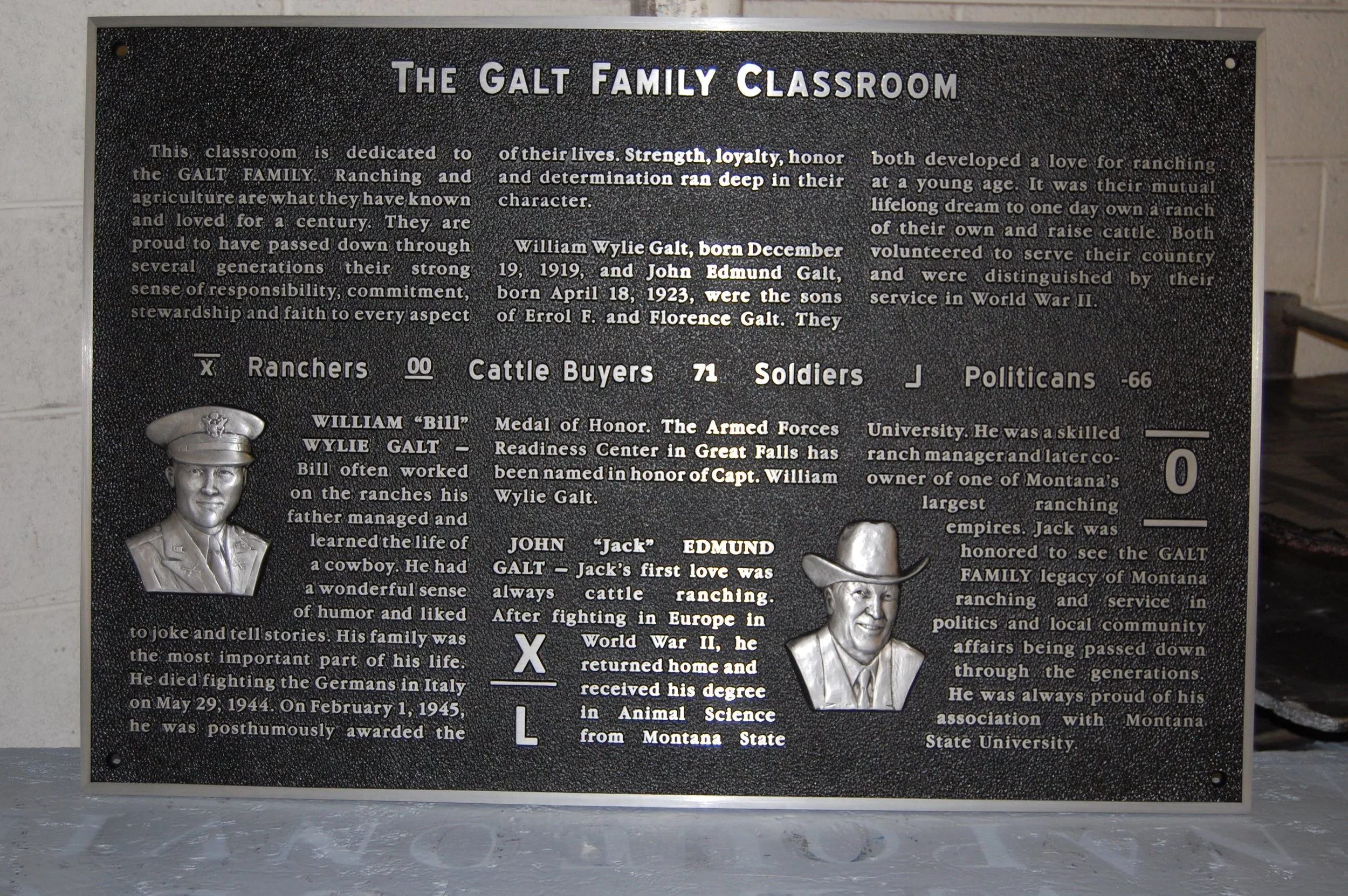 Large dedication display featuring multiple sculpted portraits and lettering crafted as custom 3d bas relief plaques for institutional recognition.