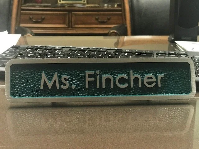 Personalized office nameplate crafted as a decorative 3d bas relief plaque with raised lettering similar to custom bas relief plaques.