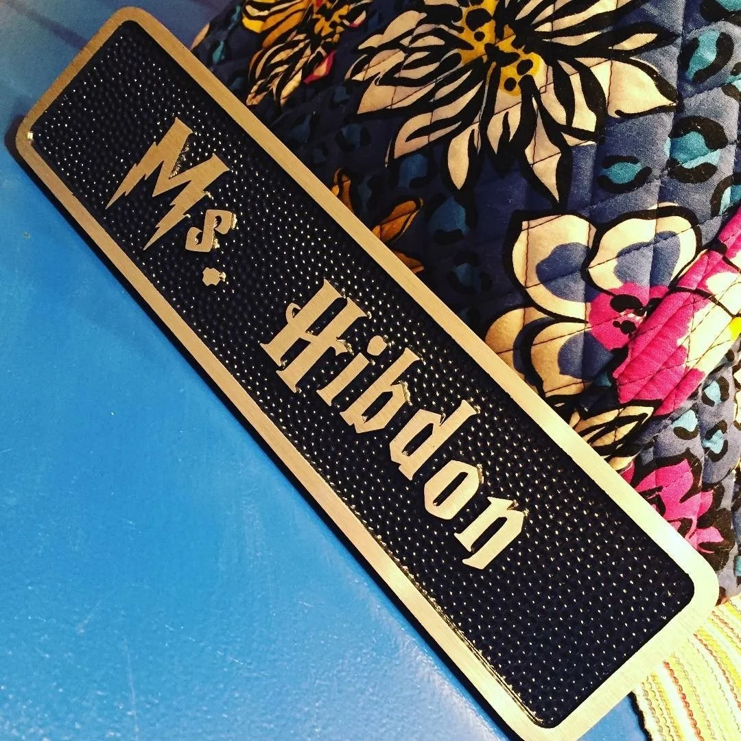 Decorative nameplate with raised lettering designed as a custom 3d bas relief plaque used for office and recognition bas relief plaques.