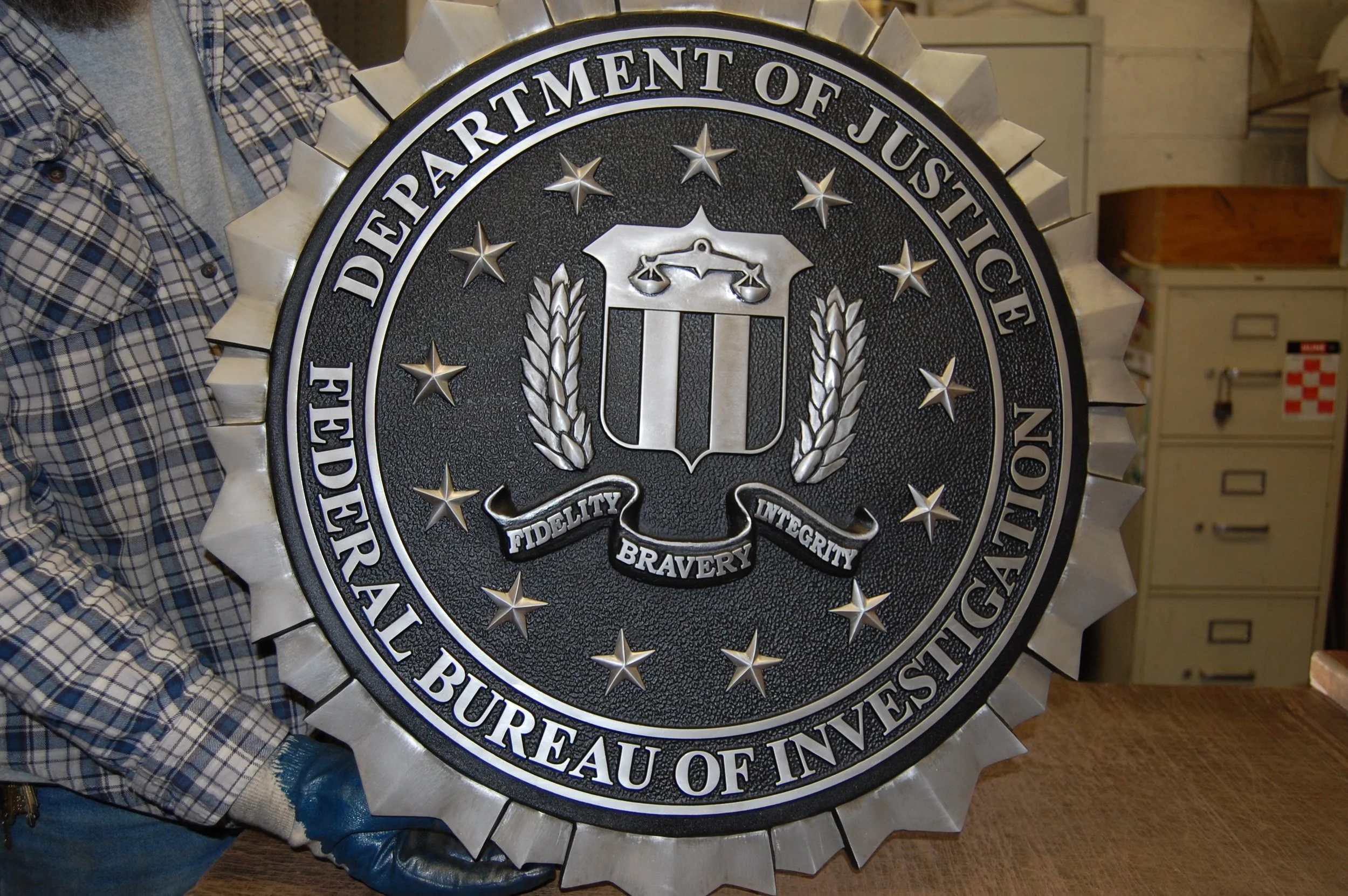 Federal Bureau of Investigation emblem cast as a detailed 3d bas relief plaque featuring sculpted stars and lettering typical of official bas relief plaques.
