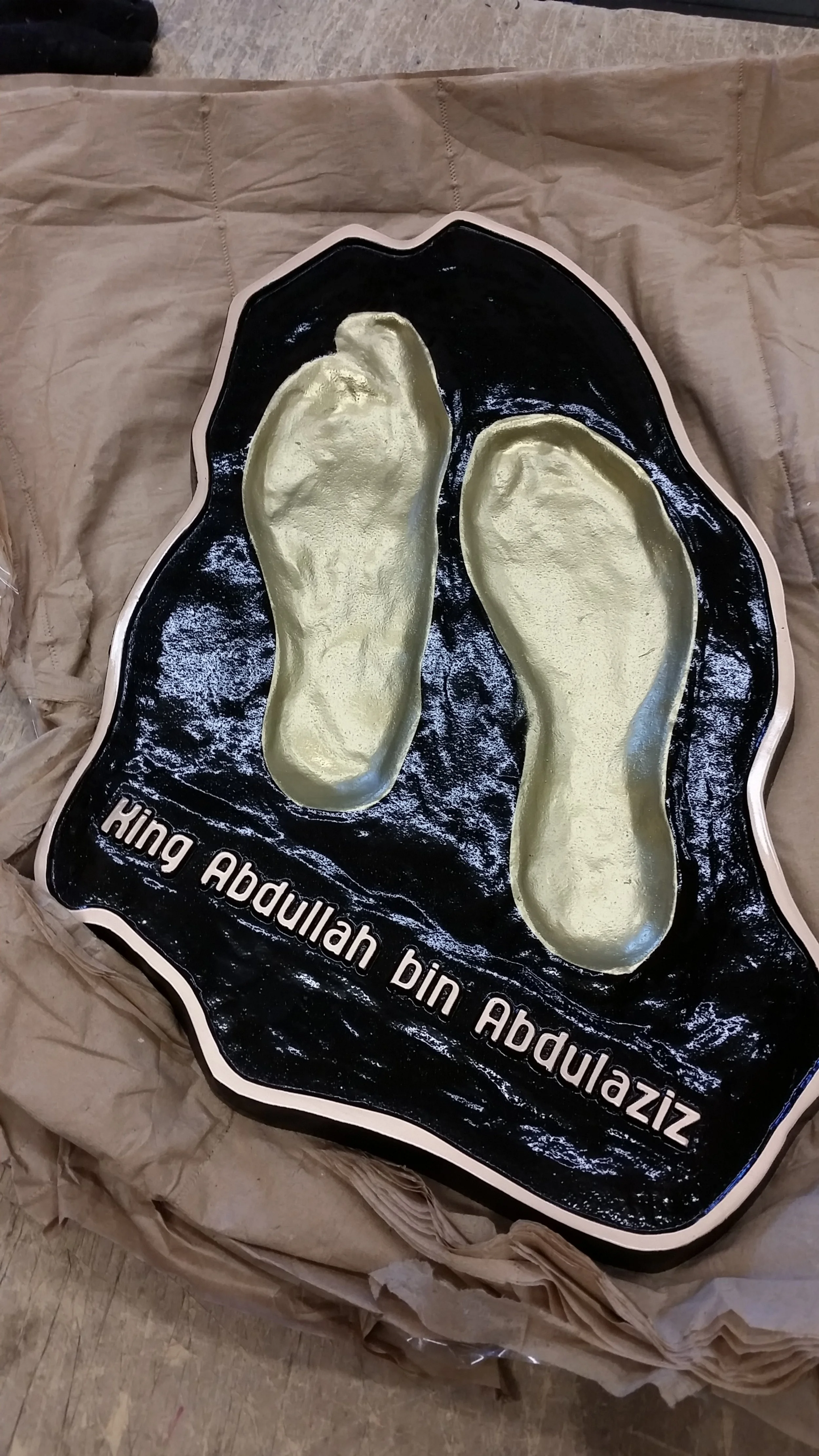 Unique custom memorial plaques featuring sculpted footprints created as a commemorative metal memorial plaque honoring King Abdullah bin Abdulaziz.