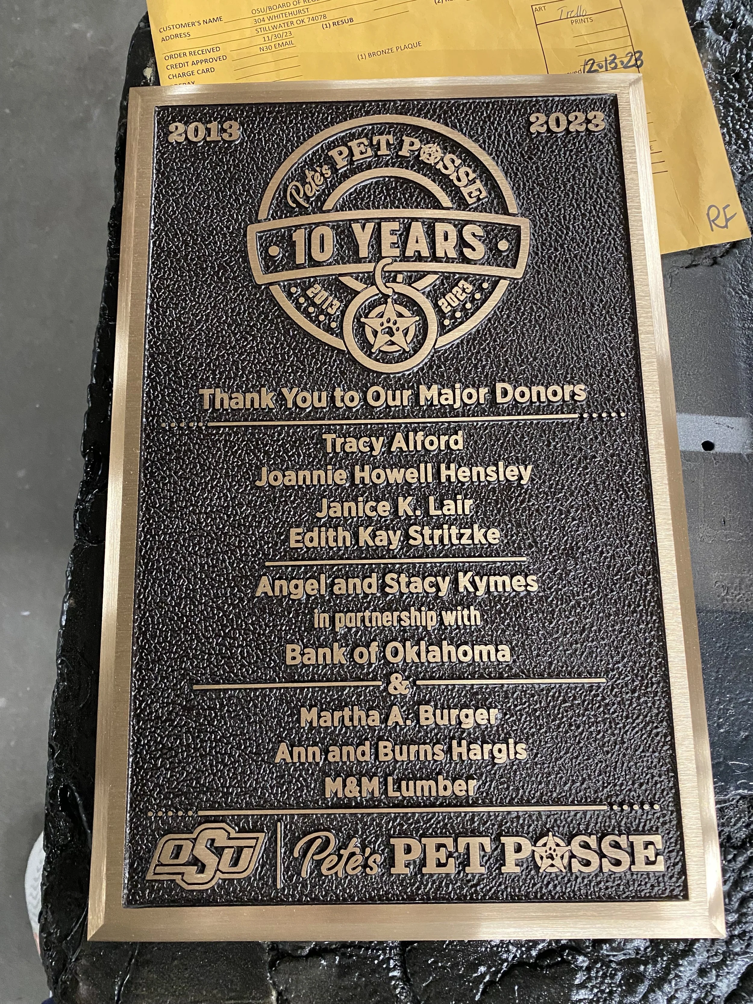Custom donor recognition plaque honoring major donors to Pete’s Pet Posse with raised bronze lettering, logos, and a textured background.