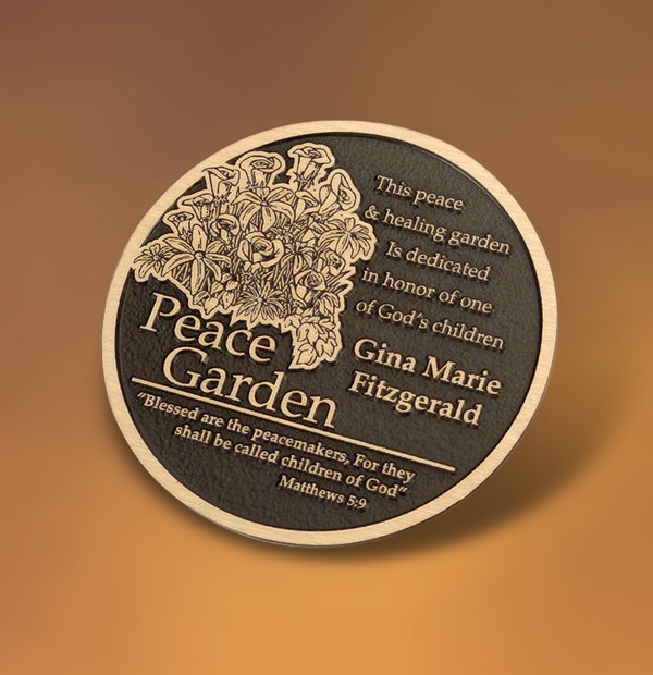 Round donor recognition plaque for a Peace Garden dedication featuring floral artwork, personalized inscription, and a bronze finish.