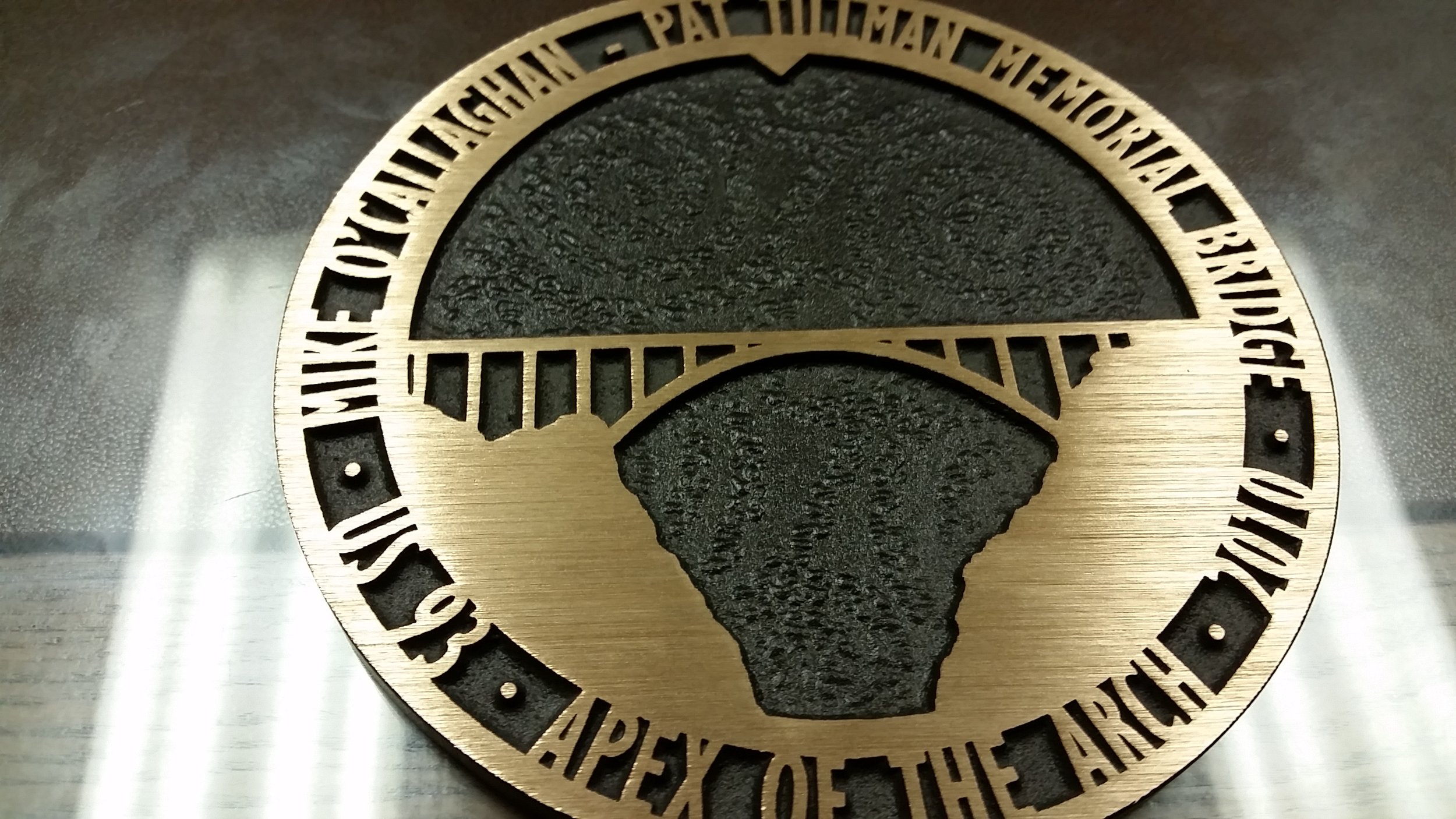 Custom bridge memorial design crafted as a 3d bas relief plaque with raised architectural elements and lettering common in civic bas relief plaques.