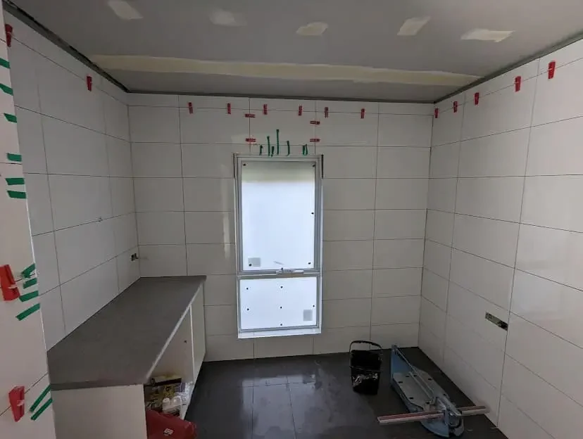 Bathroom renovation in progress showing tiling work by Massey Constructions Bendigo