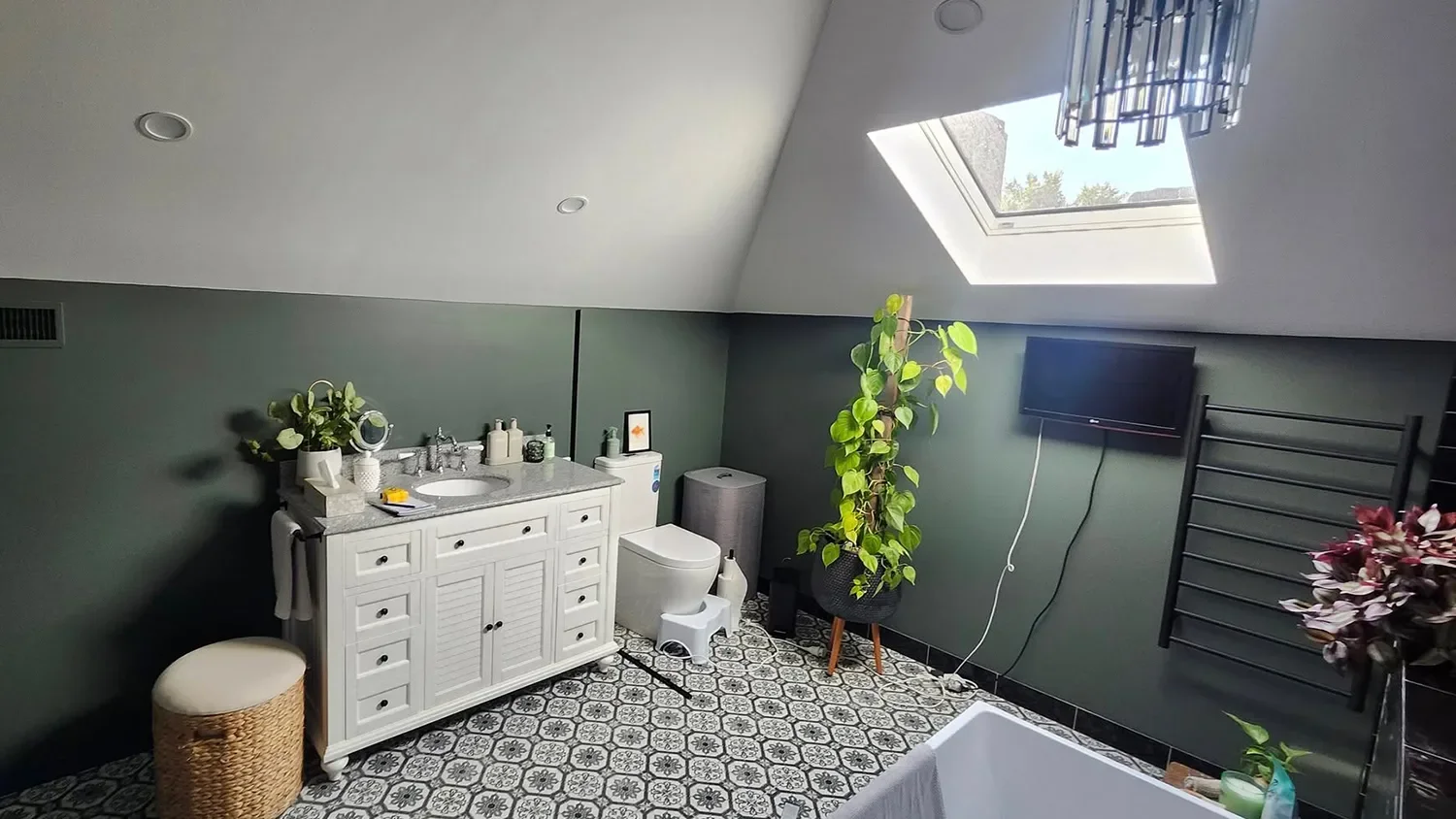 Modern bathroom renovation with freestanding bath and dark tile by Massey Constructions, Bendigo