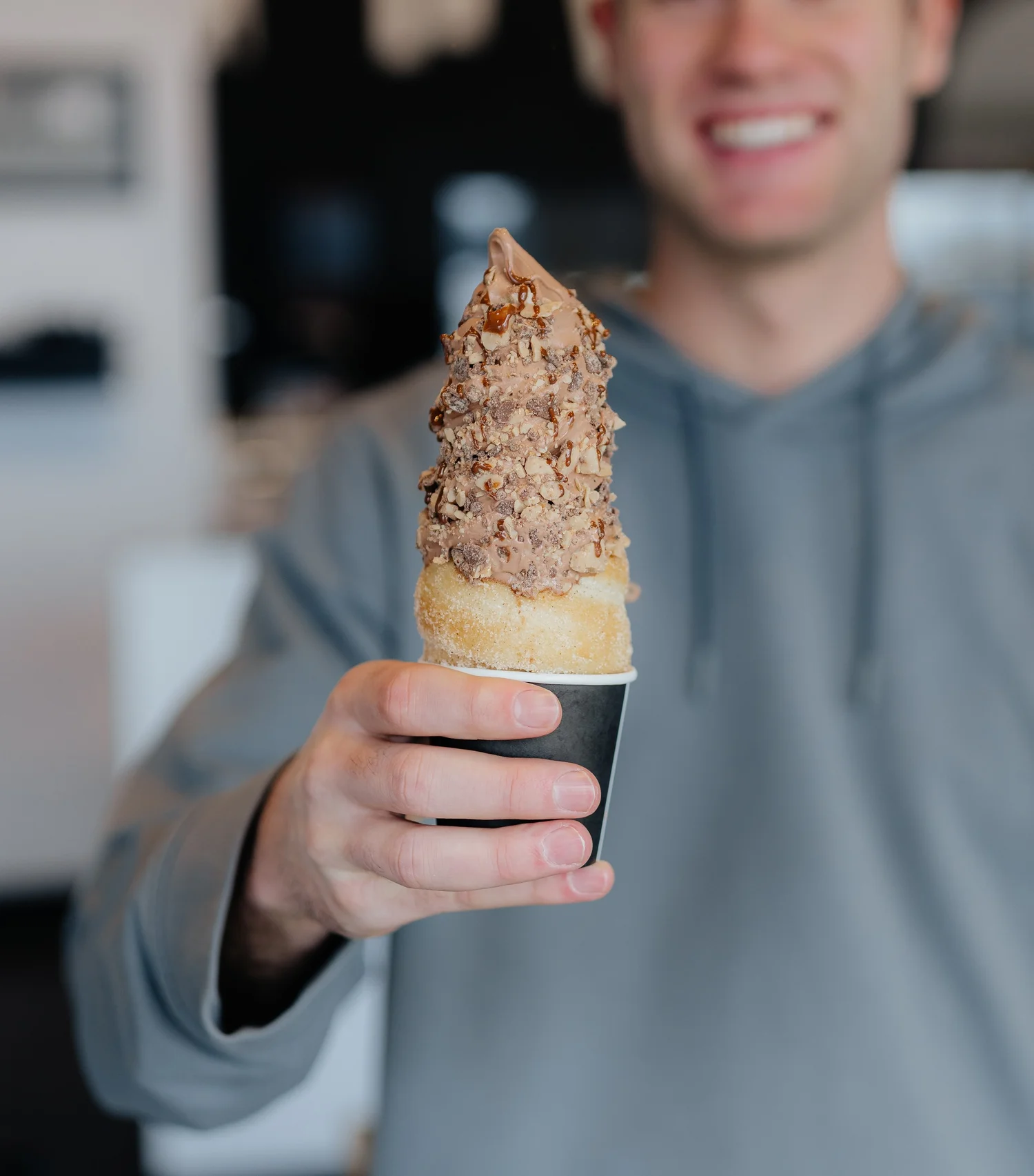 A finished Crispy Cone with soft serve ice cream, toppings and drizzle
