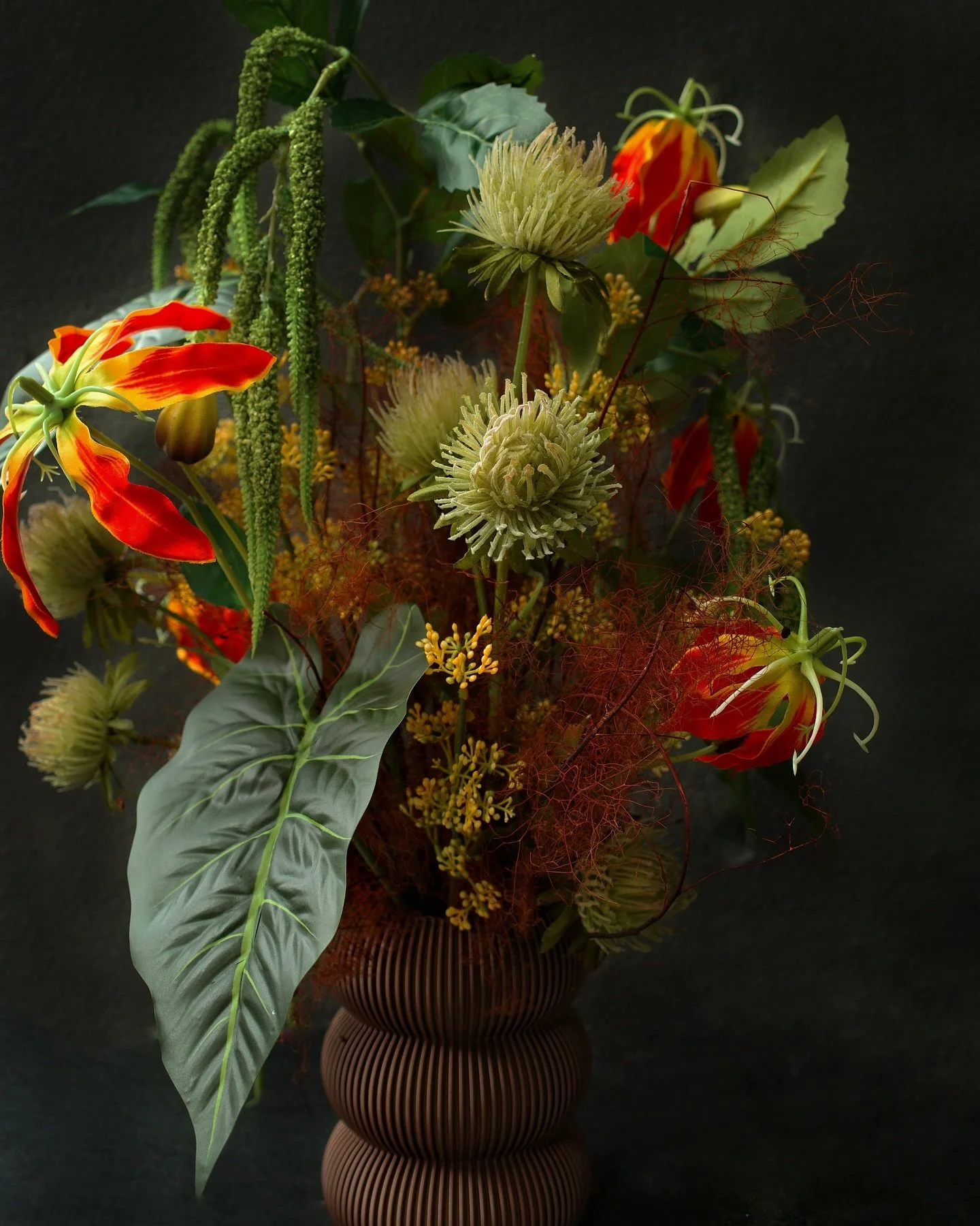 Fiery gloriosa, sculptural alocasia, and wild textures come together in this bold, untamed arrangement. A little tropical, a little edgy &mdash; made to turn heads.⁠
⁠
Not my usual style, but so glad I ventured into this wilder, more sculptural direc