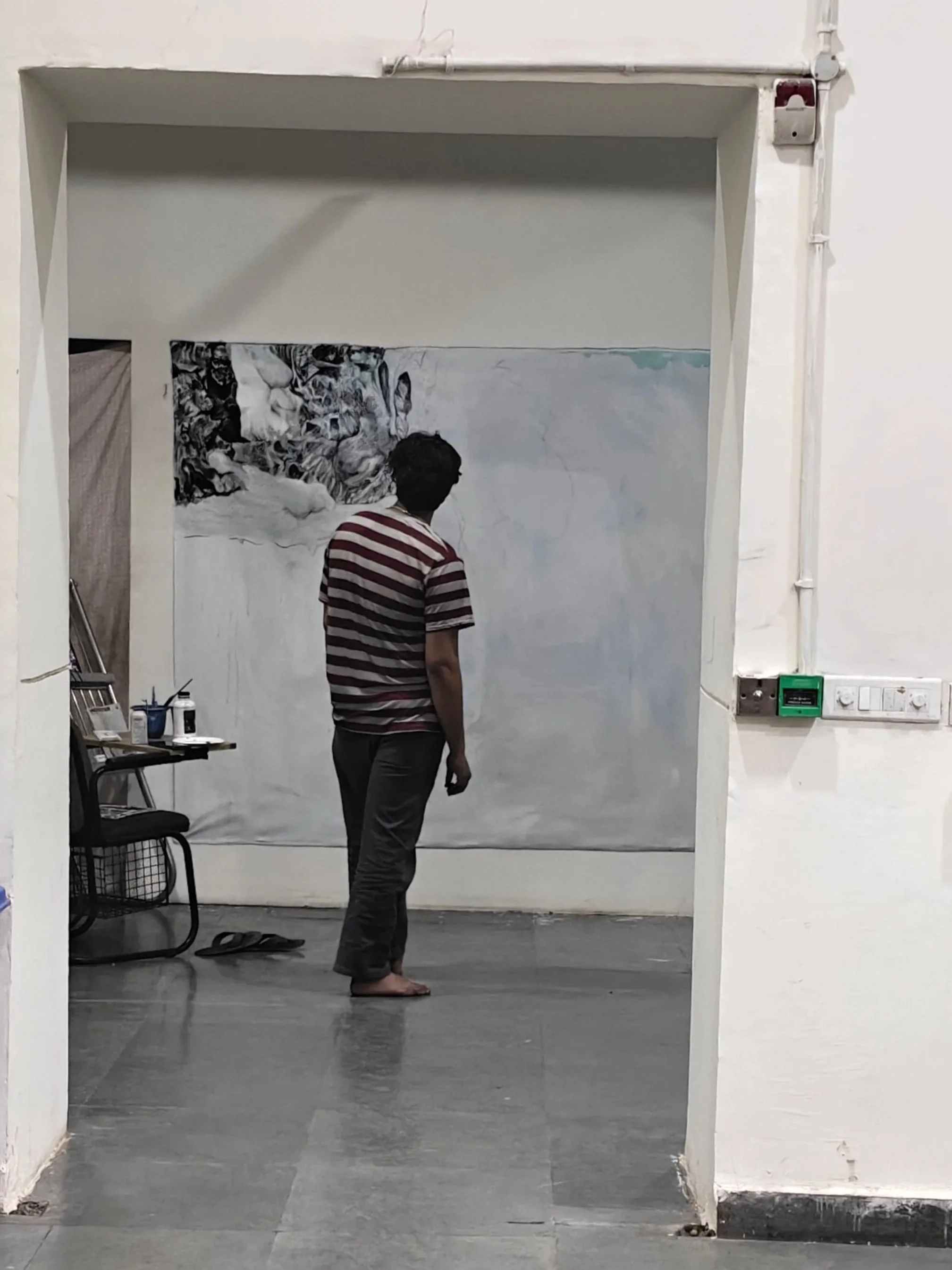 MFA student Robin working on a painting, “I am interested in bodies that cannot be contained”.
