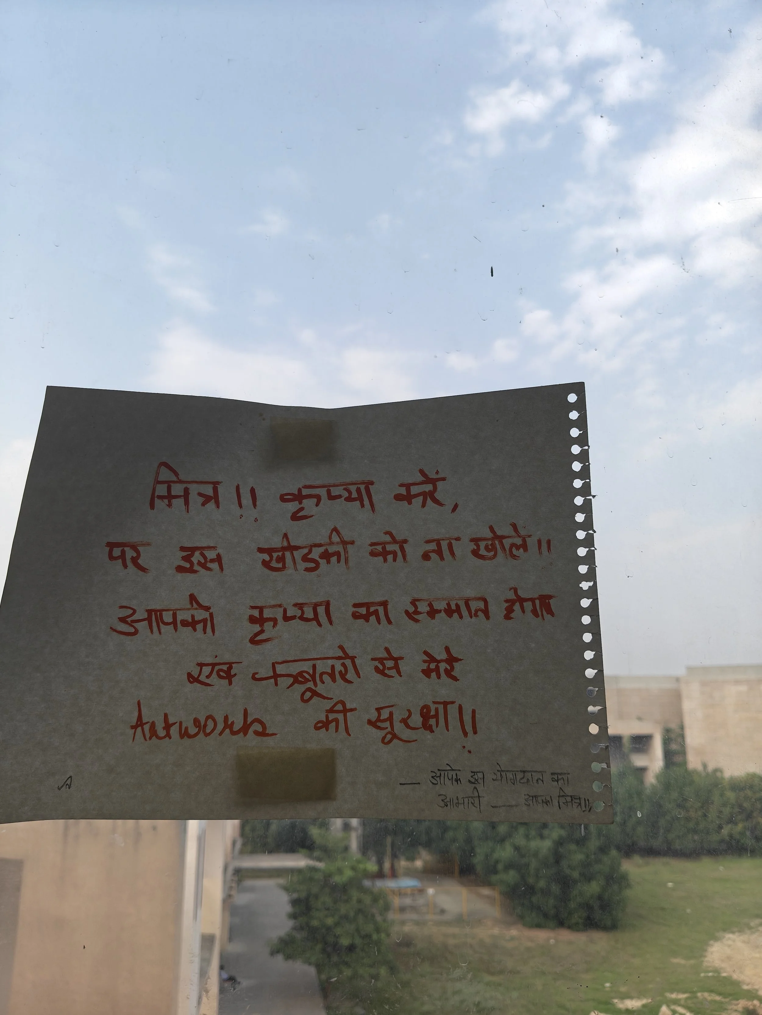 A message in the studio: “Dear friend, please do not open this window. I will be grateful as it will protect my artwork from pigeons. Thank you.”