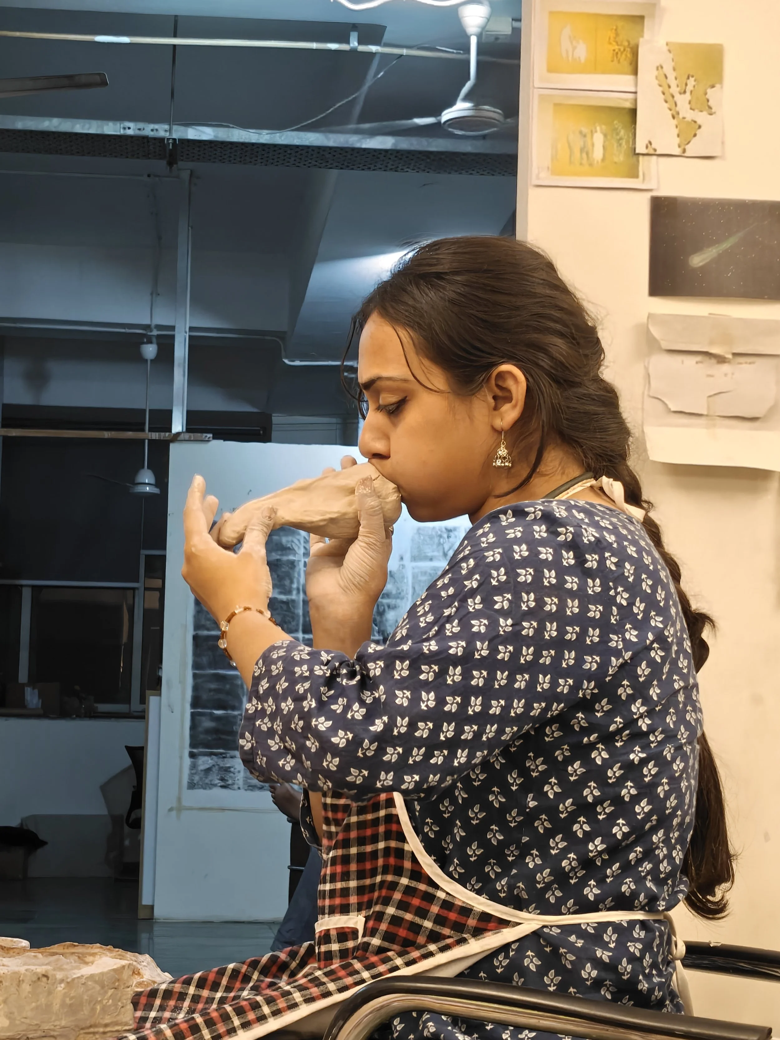 First-year MFA student Riya working in her studio
