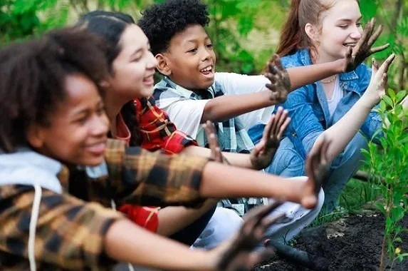 diverse students gardening composting outdoors nature school outdoor based learning soil study