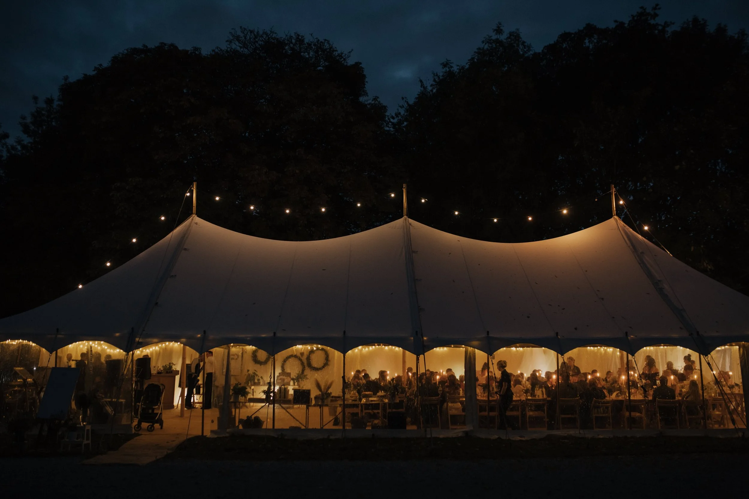 derbyshire wedding marquee setup with flying festoon in the dark