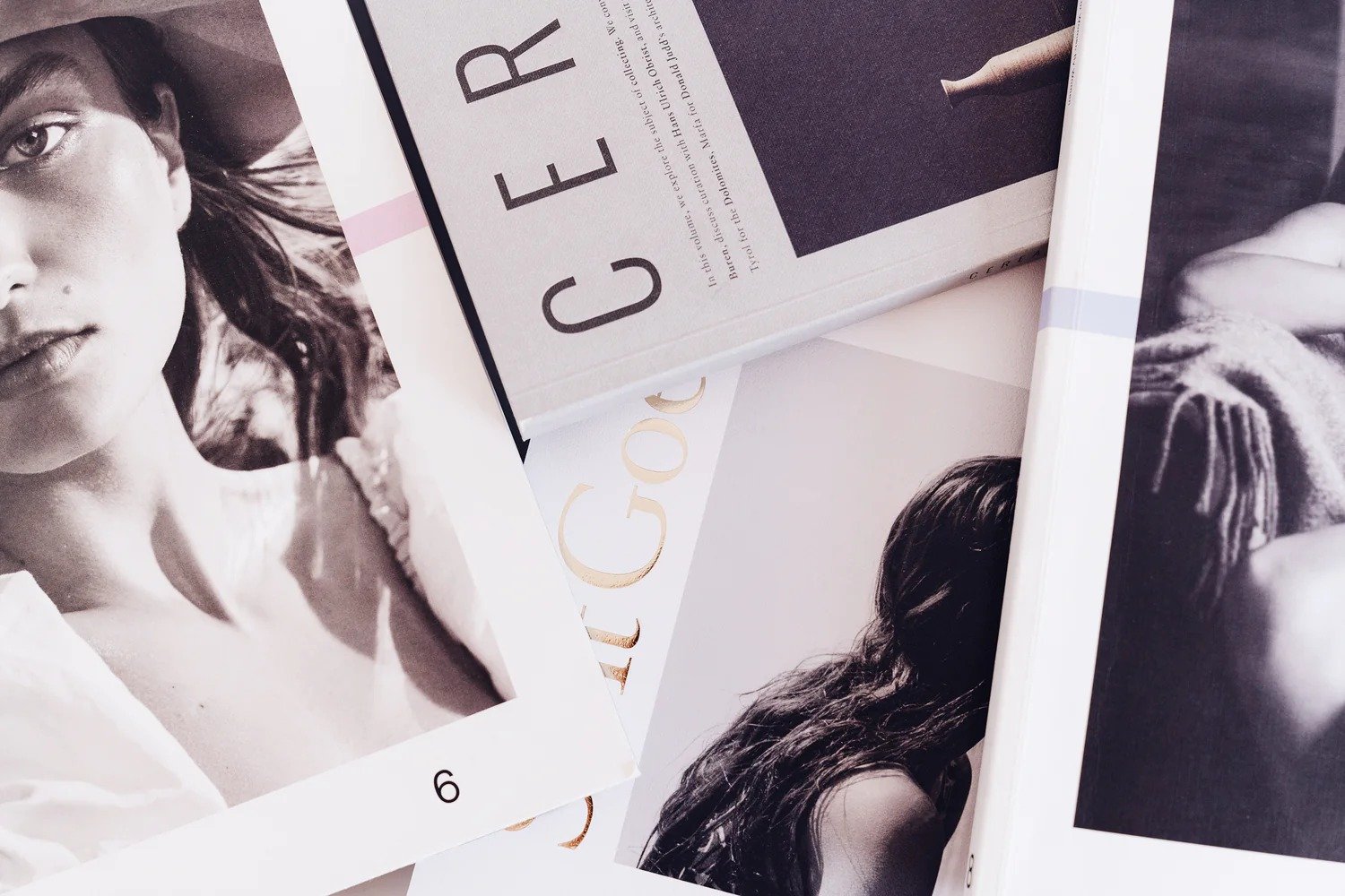 Black and white fashion photographs of women, overlapping each other, with a Vogue magazine and a book titled "CEREAR" among the images.