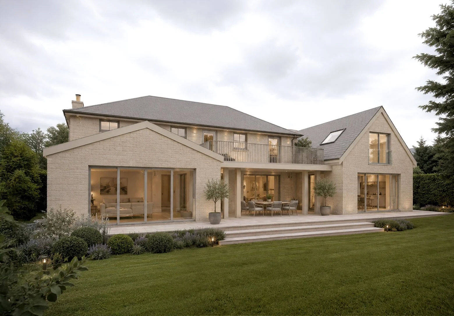Modern backyard house extension with large glass sliding doors, multiple steps leading to a lawn, and interior with dining and living spaces visible from outside, surrounded by a wooden fence.
