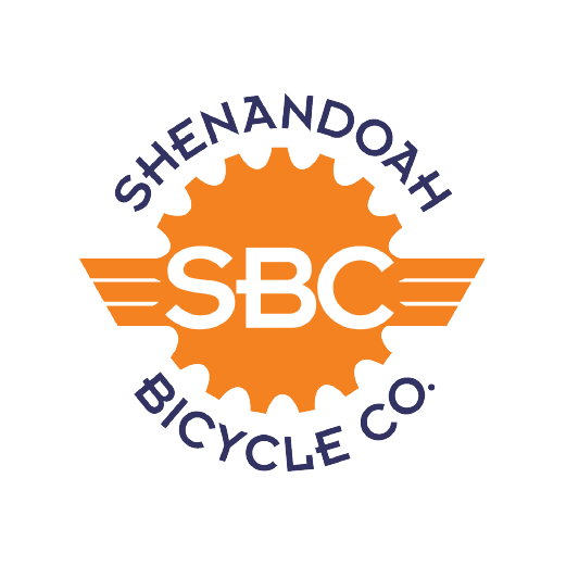 Logo of Shenandoah Bicycle Co. featuring an orange gear, with 'SBC' in white in the center, and 'SHENANDOAH BICYCLE CO.' in purple text around the gear.