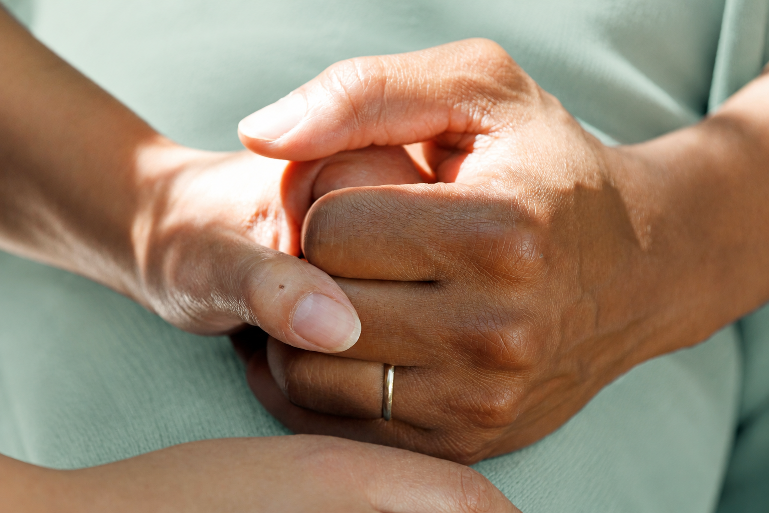 people holding hands during cancer support meeting